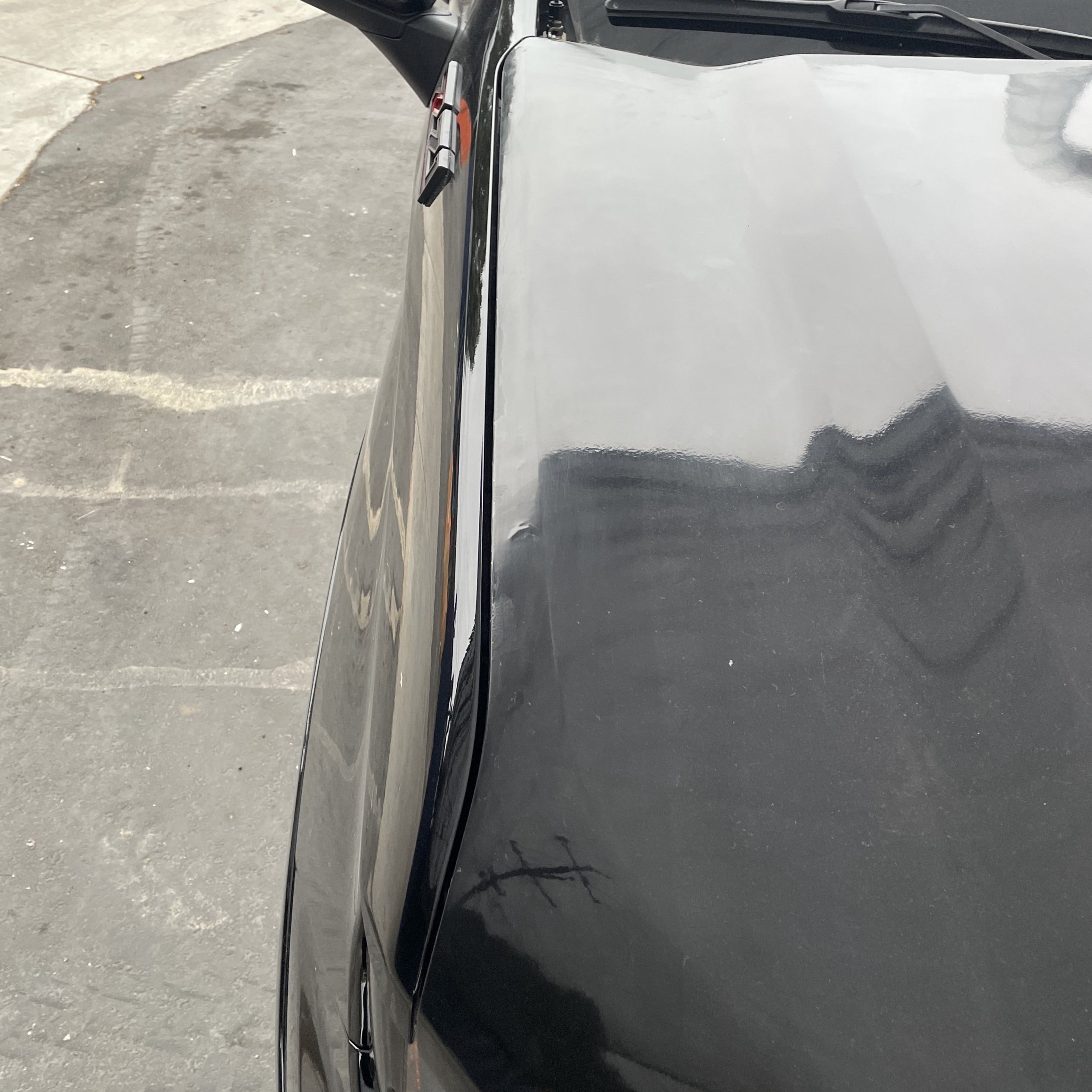 2019-2025 Chevrolet Silverado hood showcasing a sleek black finish, designed for durability and style.