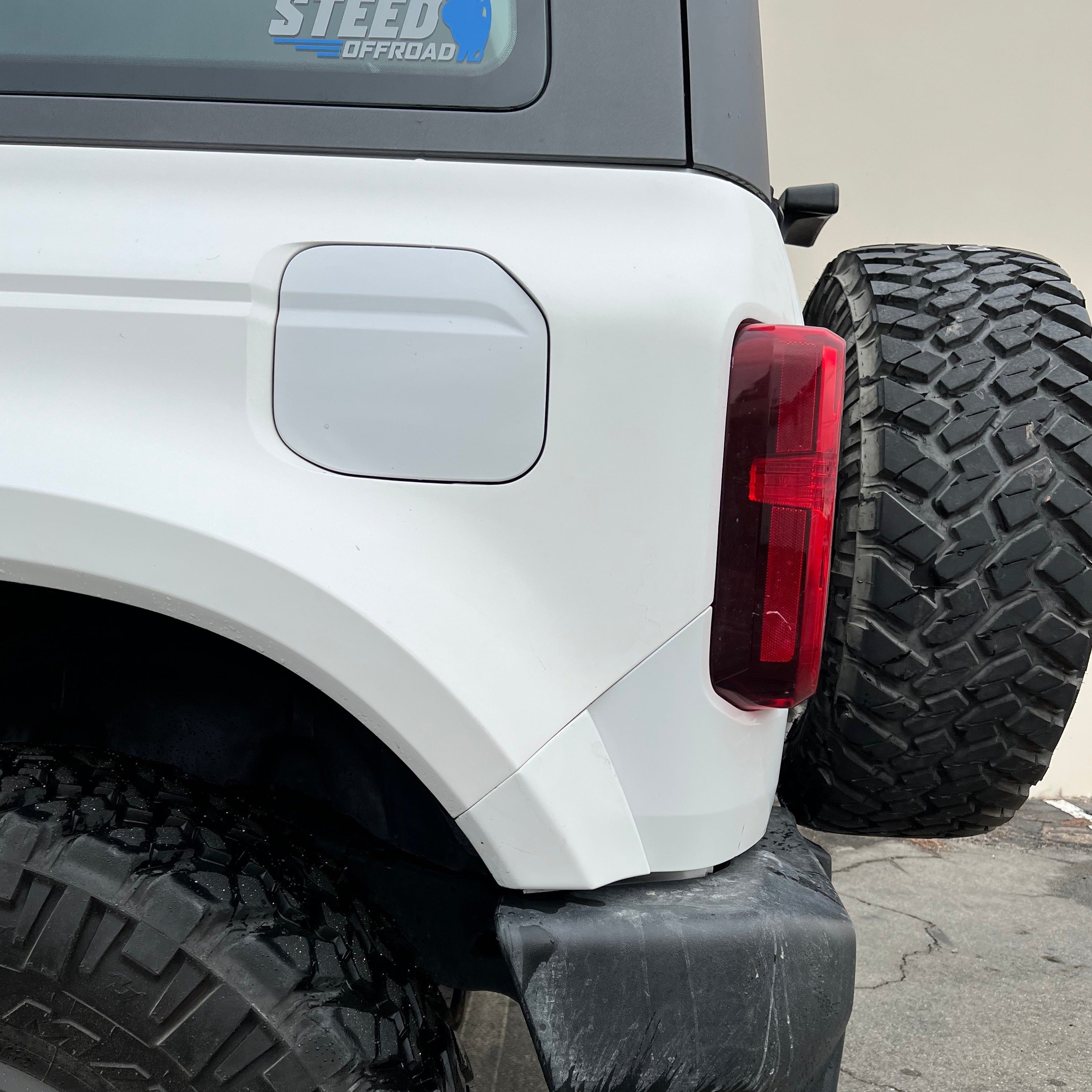 2021-2025 Ford Bronco 2-Door Rear Quarter Kit showcasing a white rear quarter panel with a spare tire mounted.