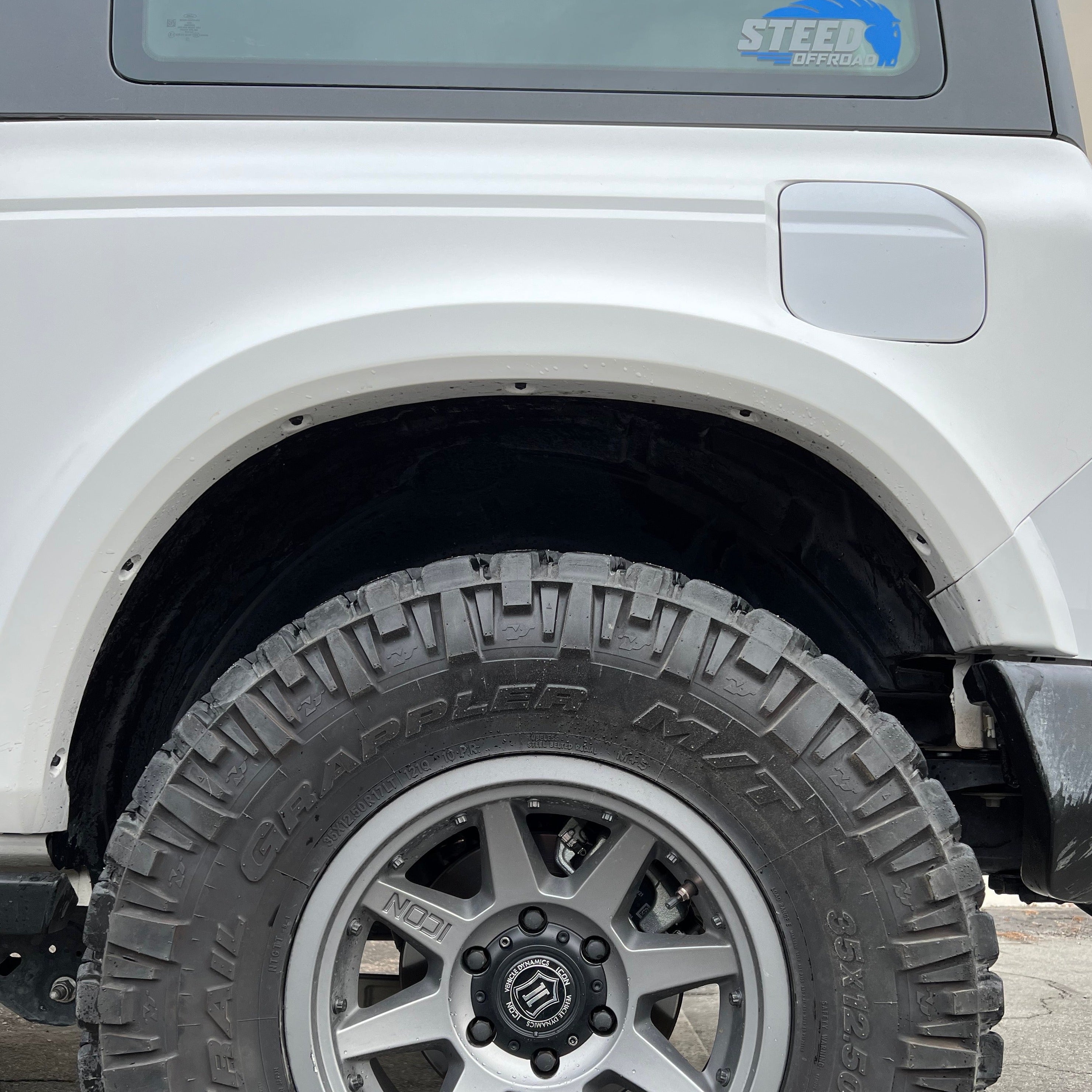 2021-2025 Ford Bronco 2-Door Rear Quarter Kit showcasing a rugged tire and wheel setup on a modified vehicle.