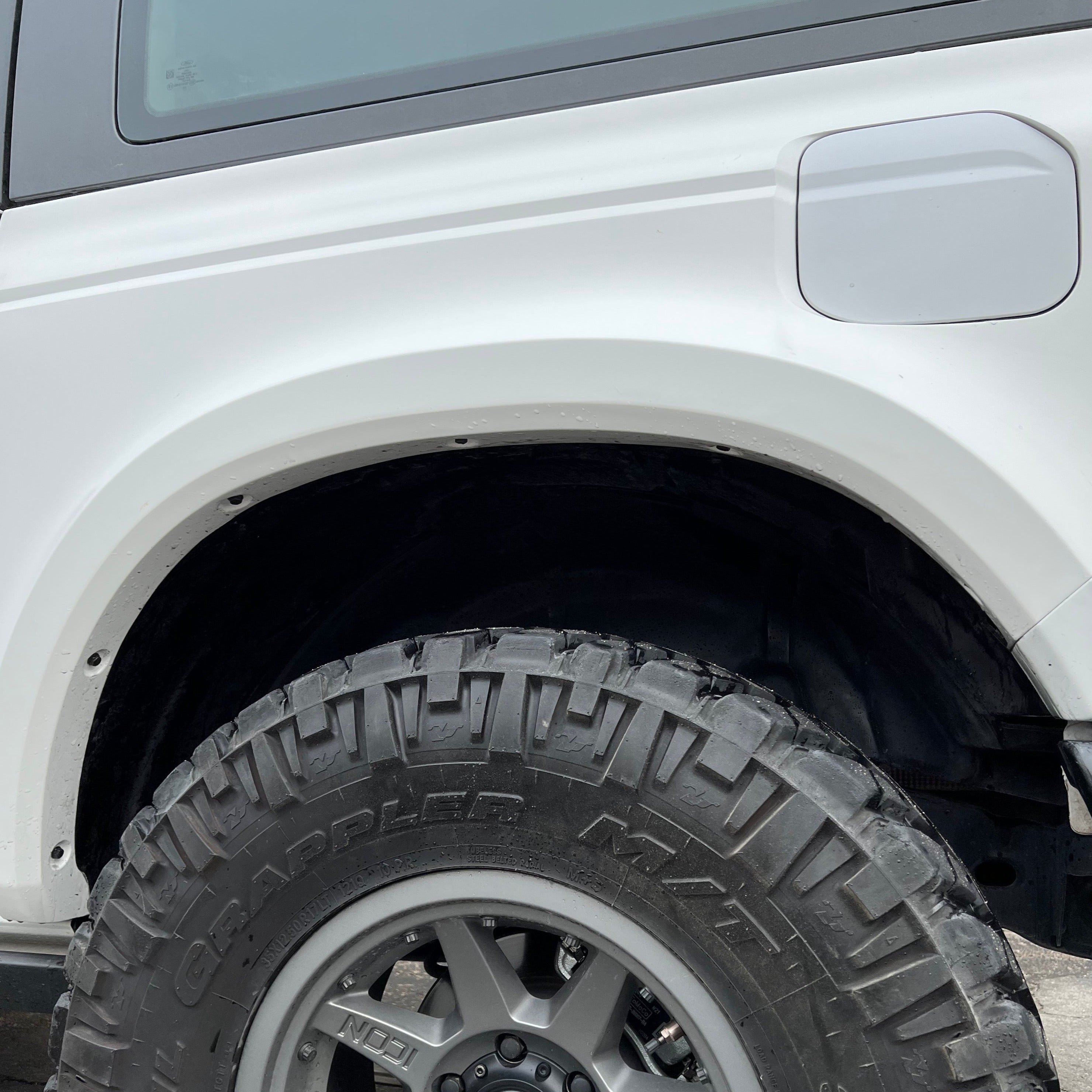 2021-2025 Ford Bronco 2-Door Rear Quarter Kit showcasing a rugged tire and wheel fitment on a white vehicle.