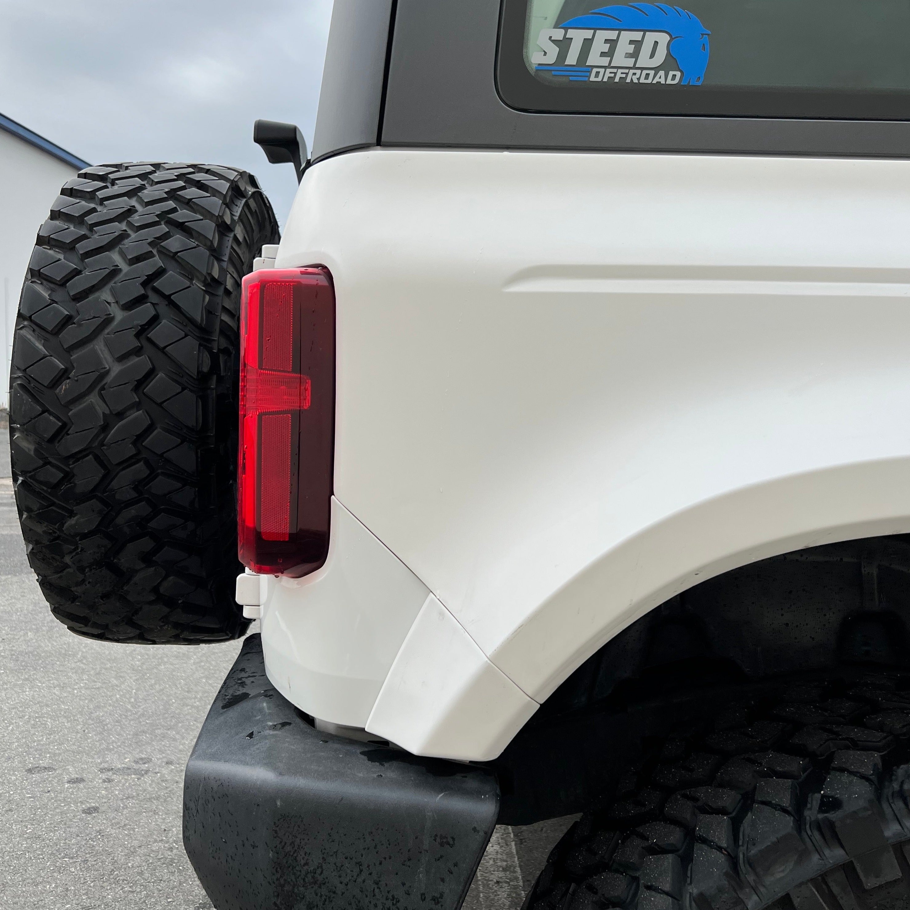 2021-2025 Ford Bronco 2-Door Rear Quarter Kit showcasing a white vehicle's rear quarter panel and tire.