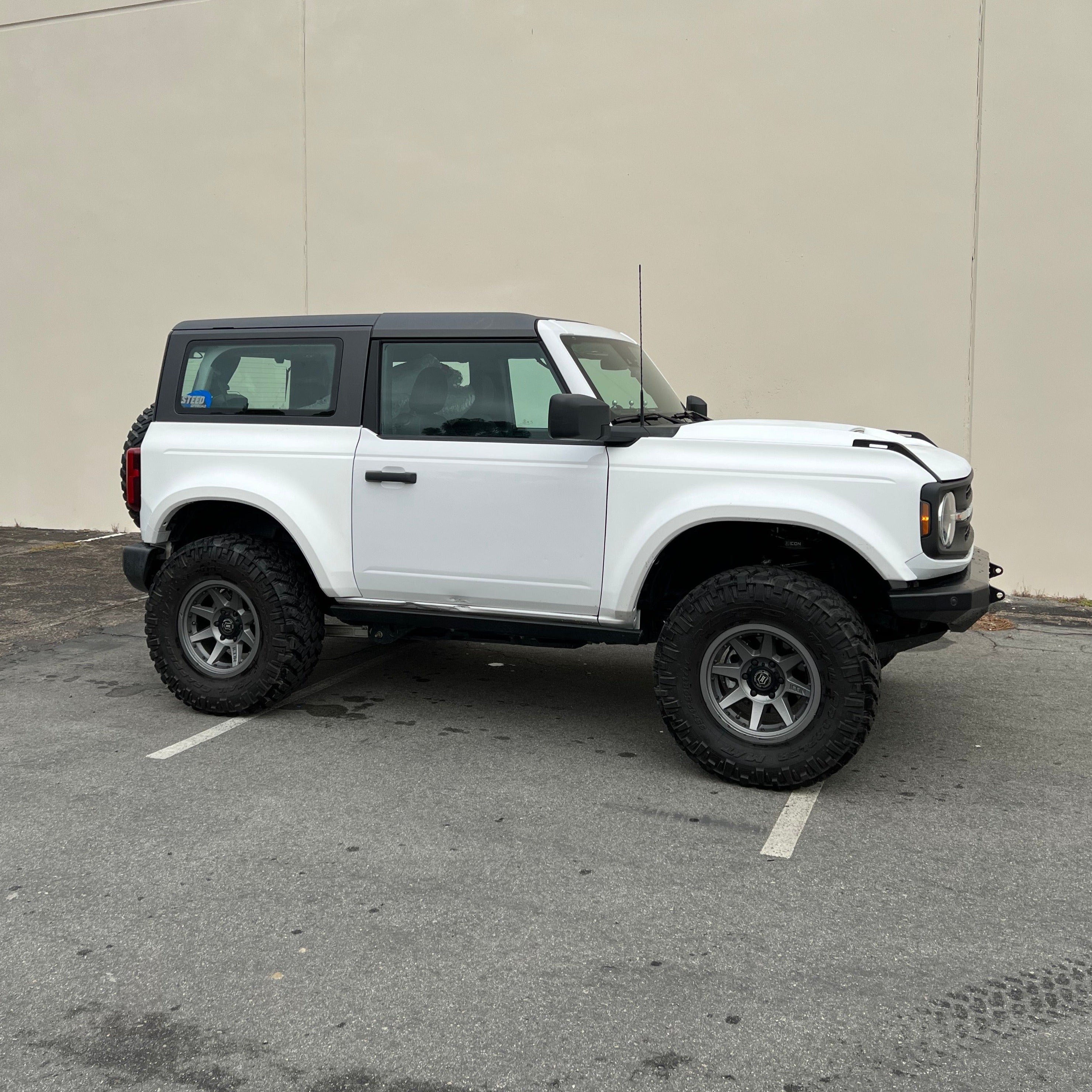2021-2025 Ford Bronco 2-Door with a rear quarter kit, showcasing an offroad-ready design and rugged tires.