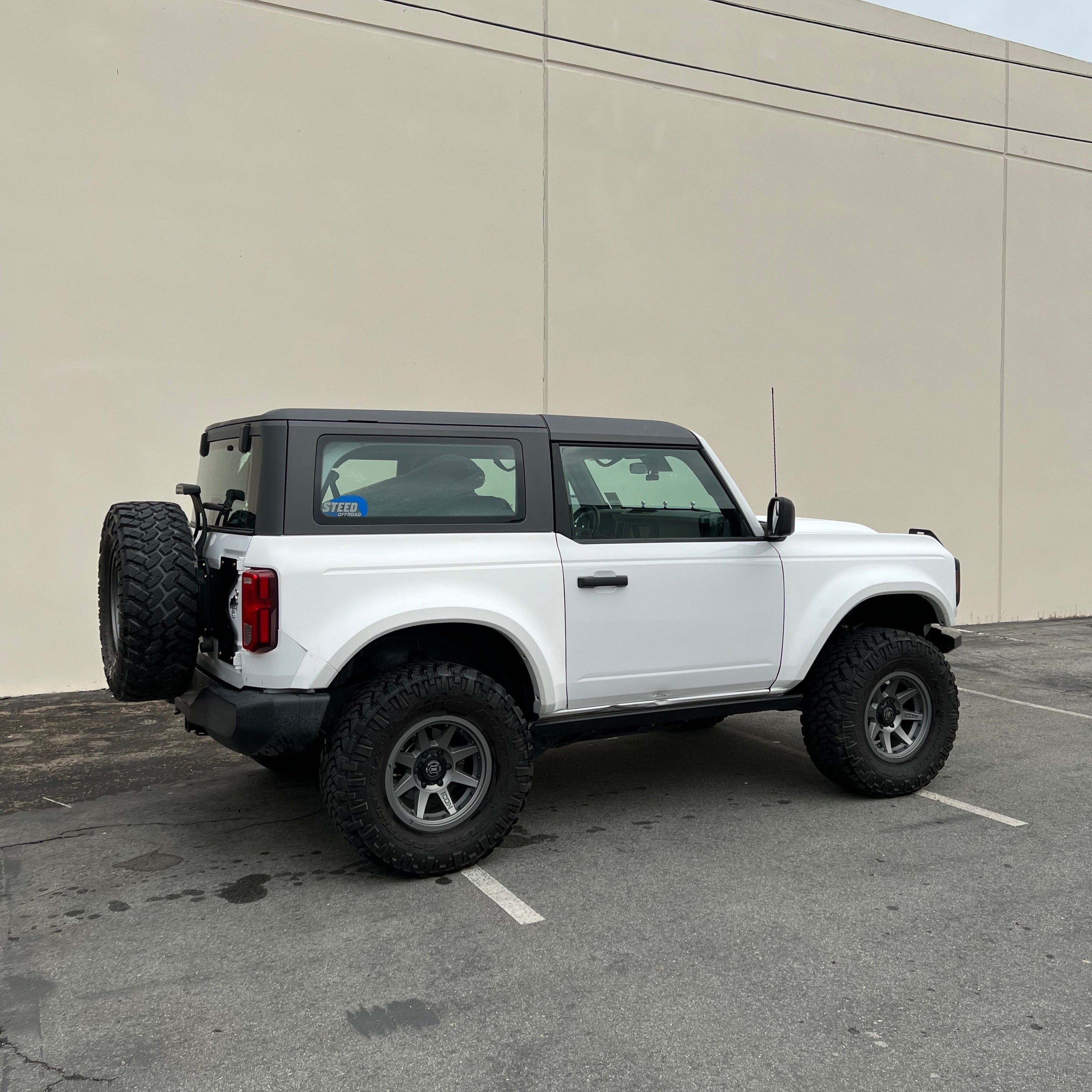 2021-2025 Ford Bronco 2-Door with a rear quarter kit, showcasing rugged off-road tires and a sleek design.