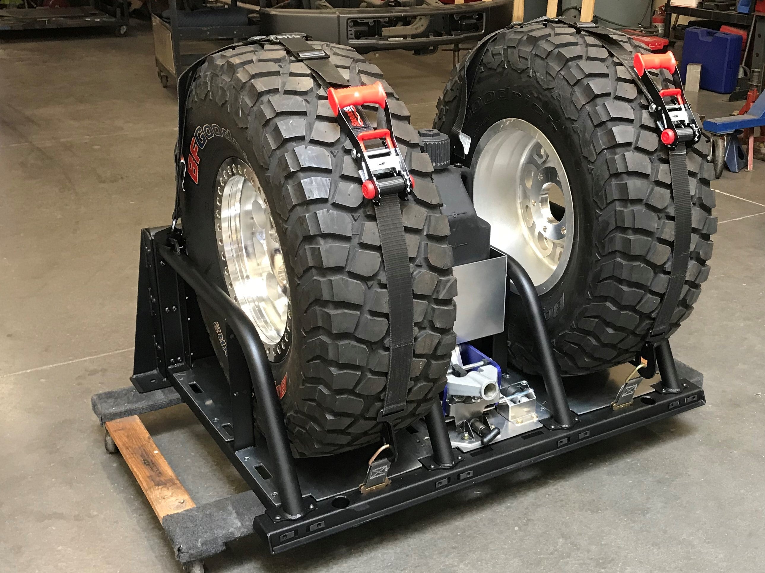Modular bed organizer for 2017-2024 Ford Raptor featuring a slide-out cargo tray and secure tire storage.
