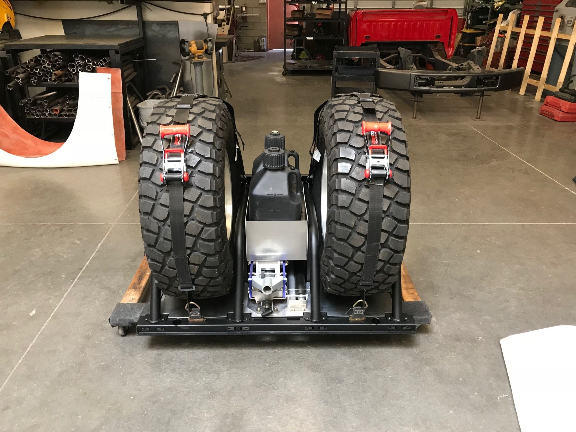 Modular bed organizer for 2017-2024 Ford Raptor featuring a slide-out cargo tray and secured tires. Ideal for offroad storage.
