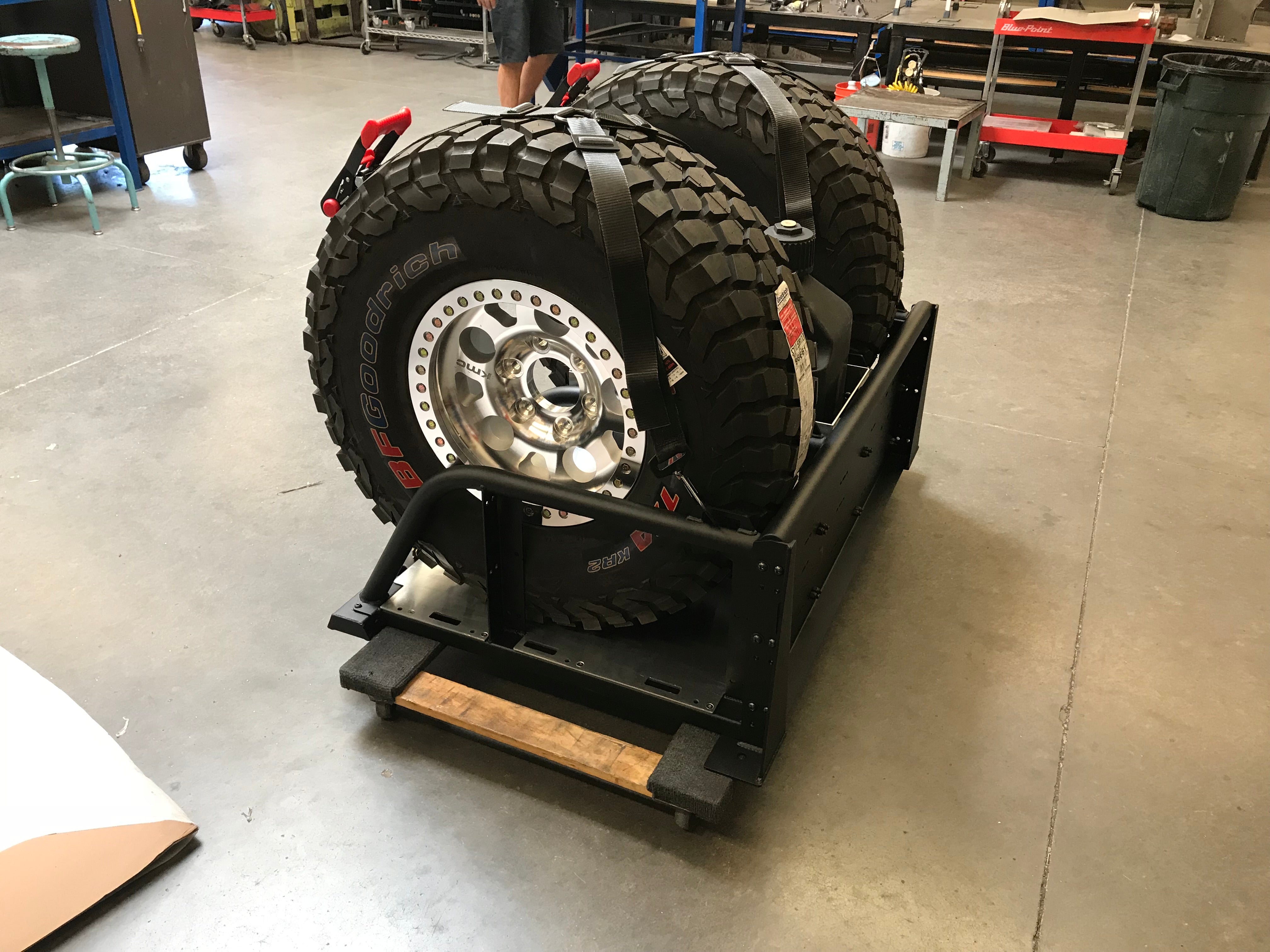 Modular bed organizer for 2017-2024 Ford Raptor featuring a slide-out cargo tray and mounted spare tires.
