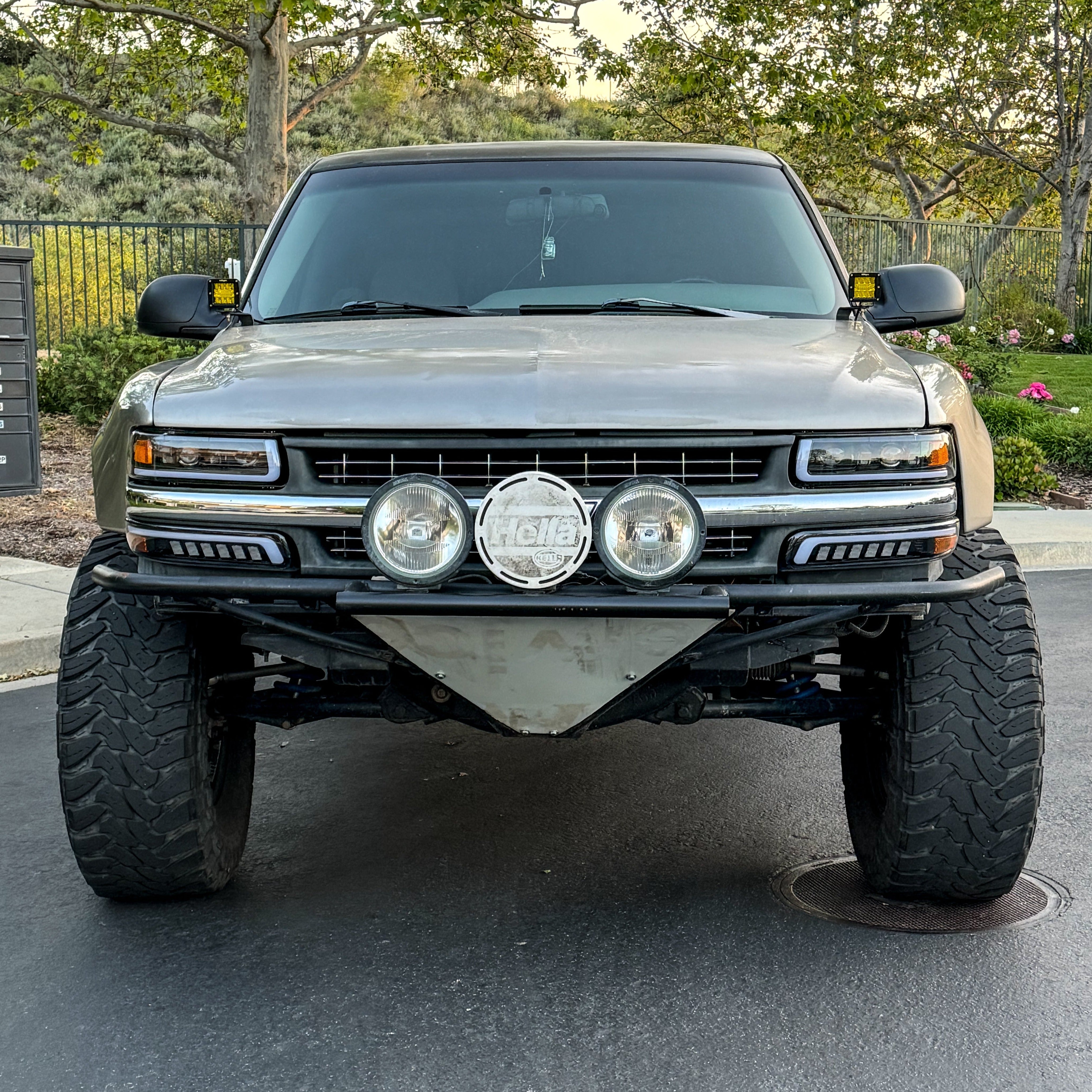 1999-2002 Chevrolet Silverado fenders displayed on a lifted truck with offroad lights and rugged tires.