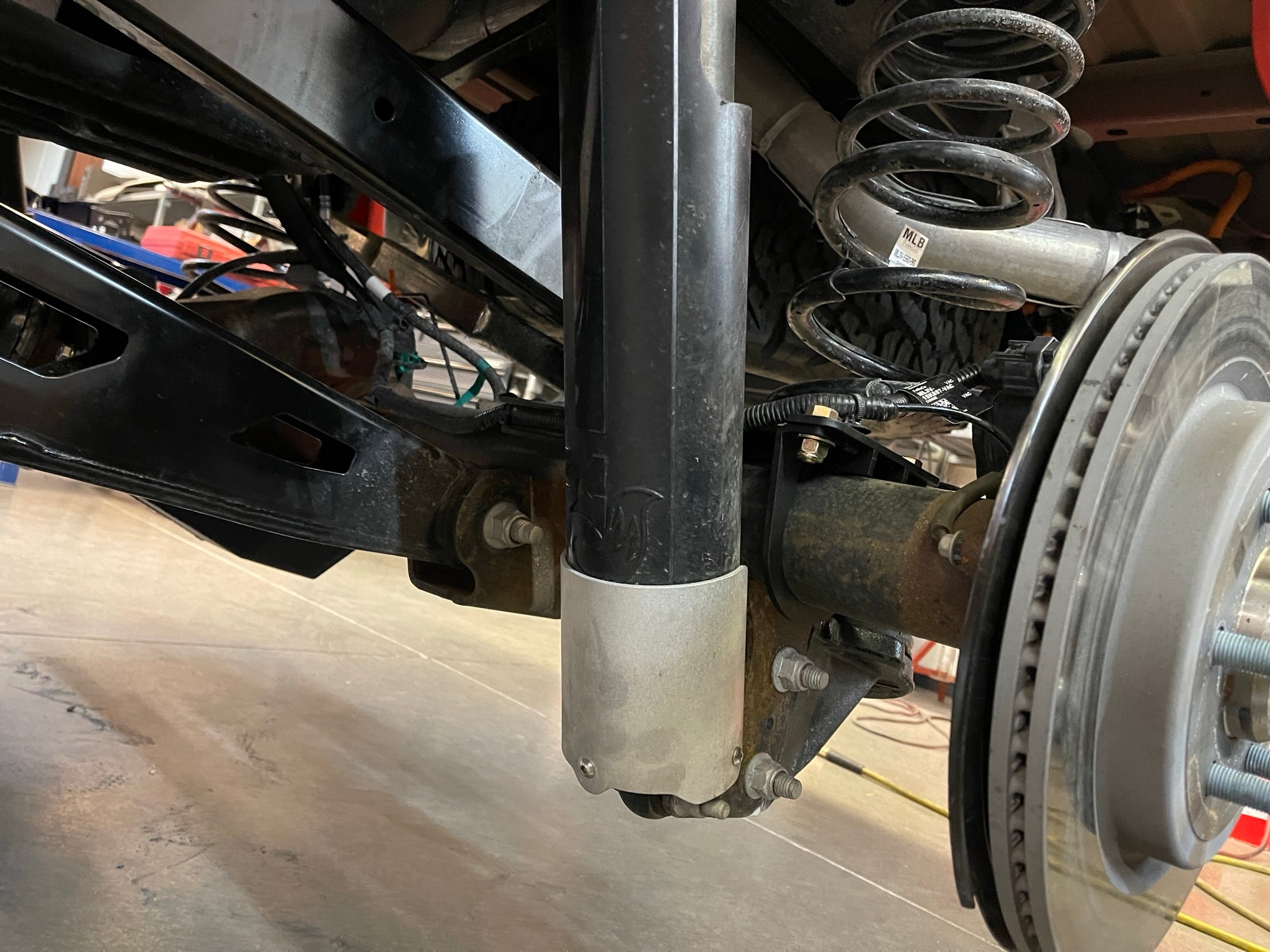 Rear shock guard for 2017-2024 Ford Raptor, designed to protect the shock absorber from debris and damage.