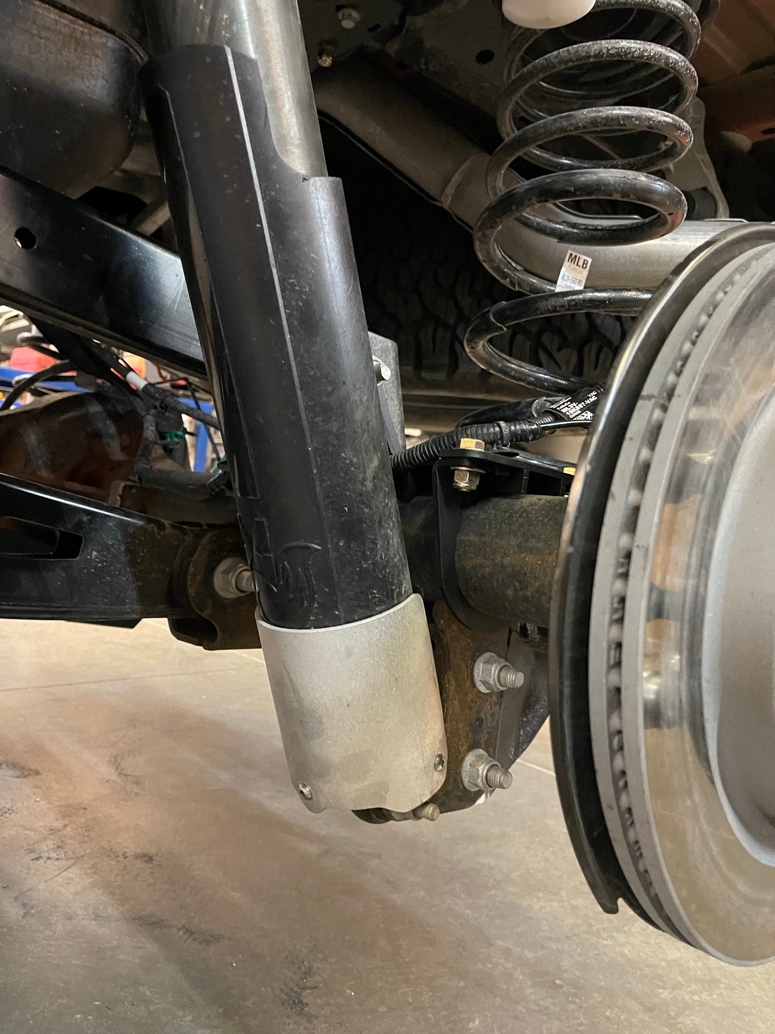 Rear shock guard for 2017-2024 Ford Raptor, designed to protect the shock from debris and damage.