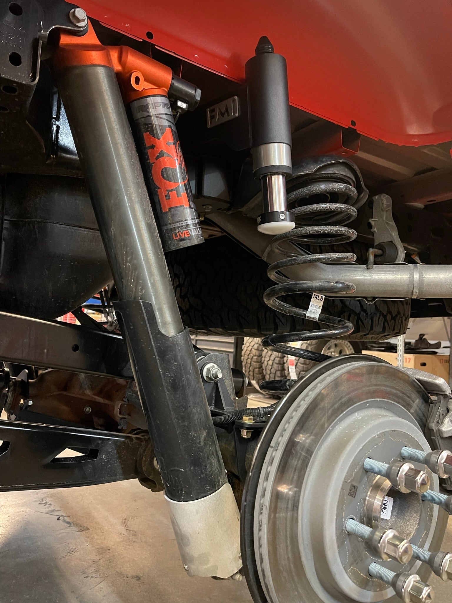 Rear view of a 2021-2024 Ford Raptor showcasing the bump stop kit, including FOX shocks and suspension components.