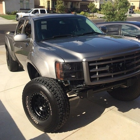 2007-2013 GMC Sierra fenders installed on a lifted truck with offroad tires, showcasing rugged design and fit.