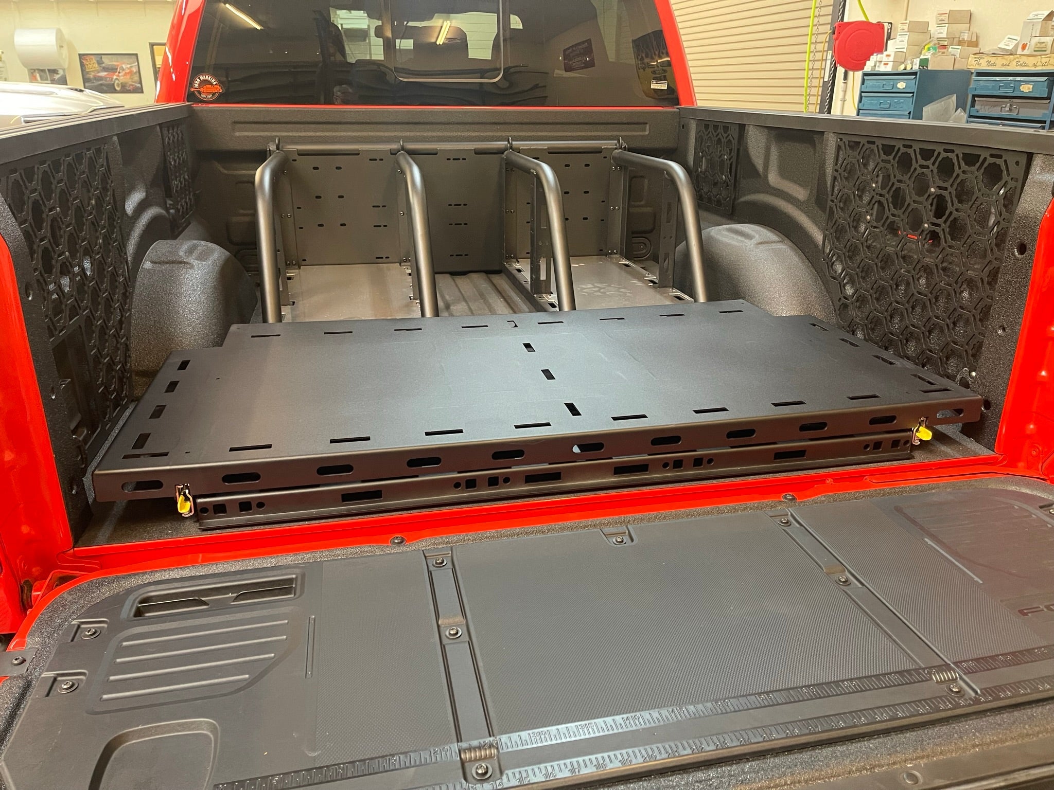 Raptor rear bed organizer with an ADD on rear cargo slide tray installed in a truck bed, showcasing storage efficiency.