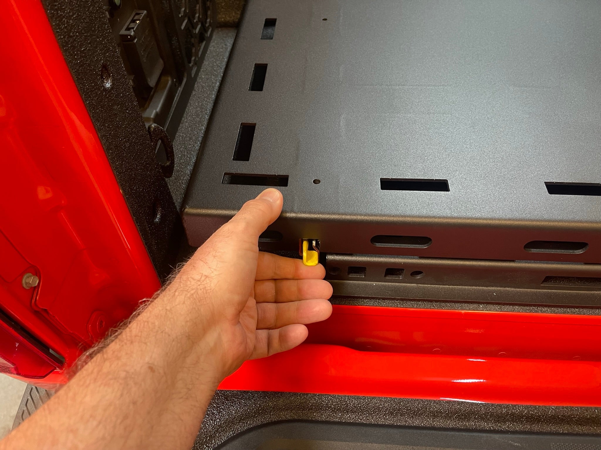 Rear bed organizer for 2017-2024 Raptor featuring a cargo slide tray, showcasing easy access and secure installation.