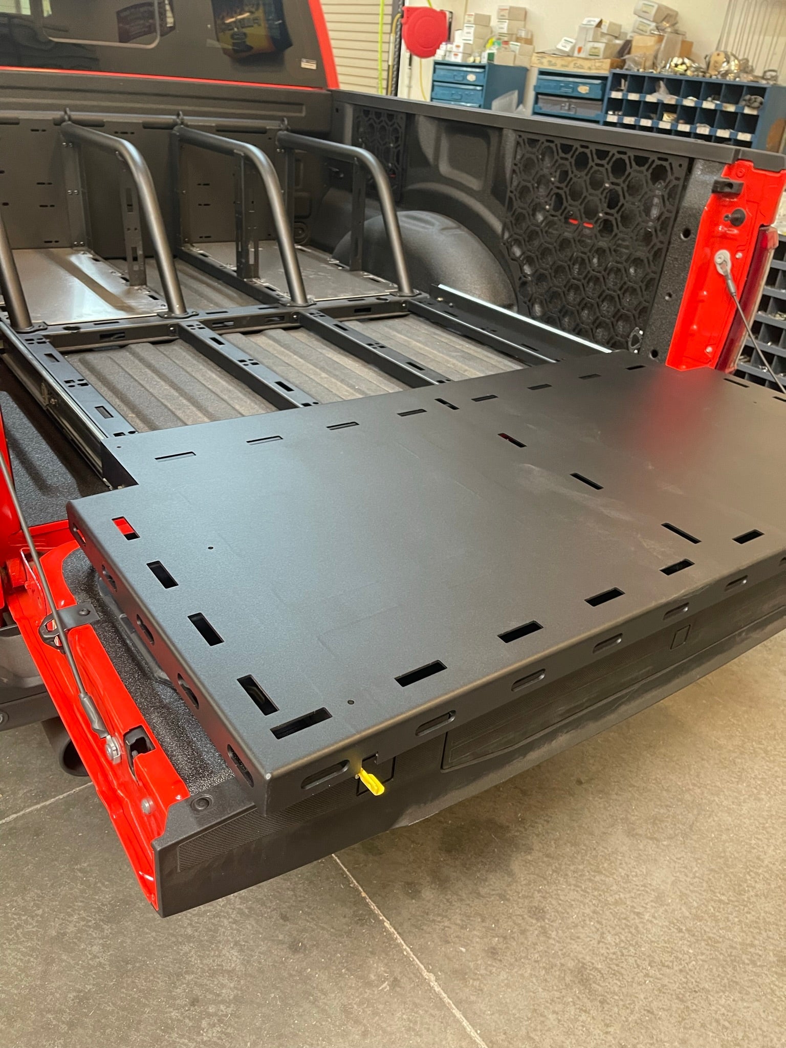 Raptor rear bed organizer with an ADD on rear cargo slide tray, showcasing a durable black design for efficient storage.
