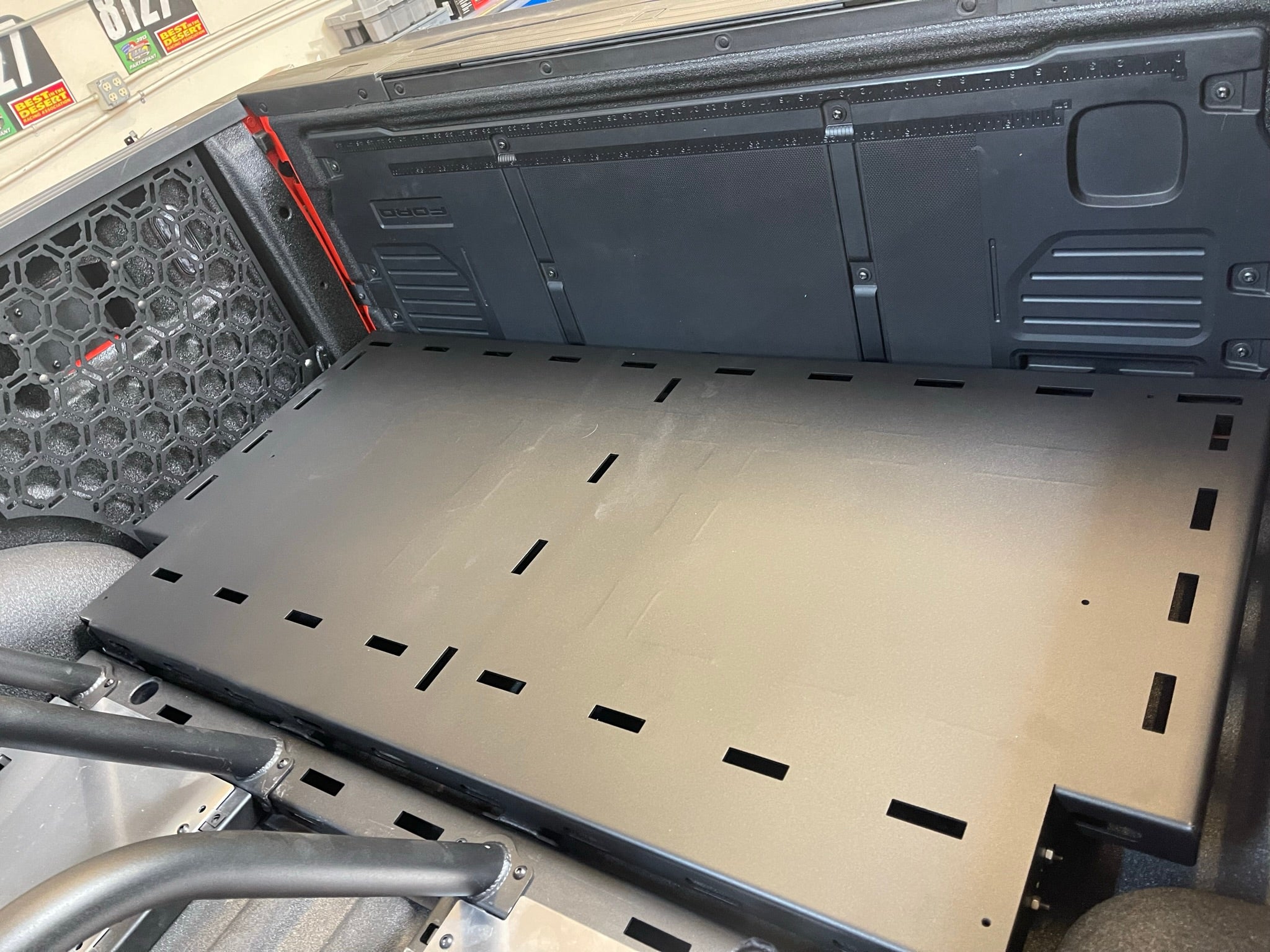 Modular bed organizer for 2017-2024 Ford Raptor featuring a slide-out cargo tray for efficient storage solutions.