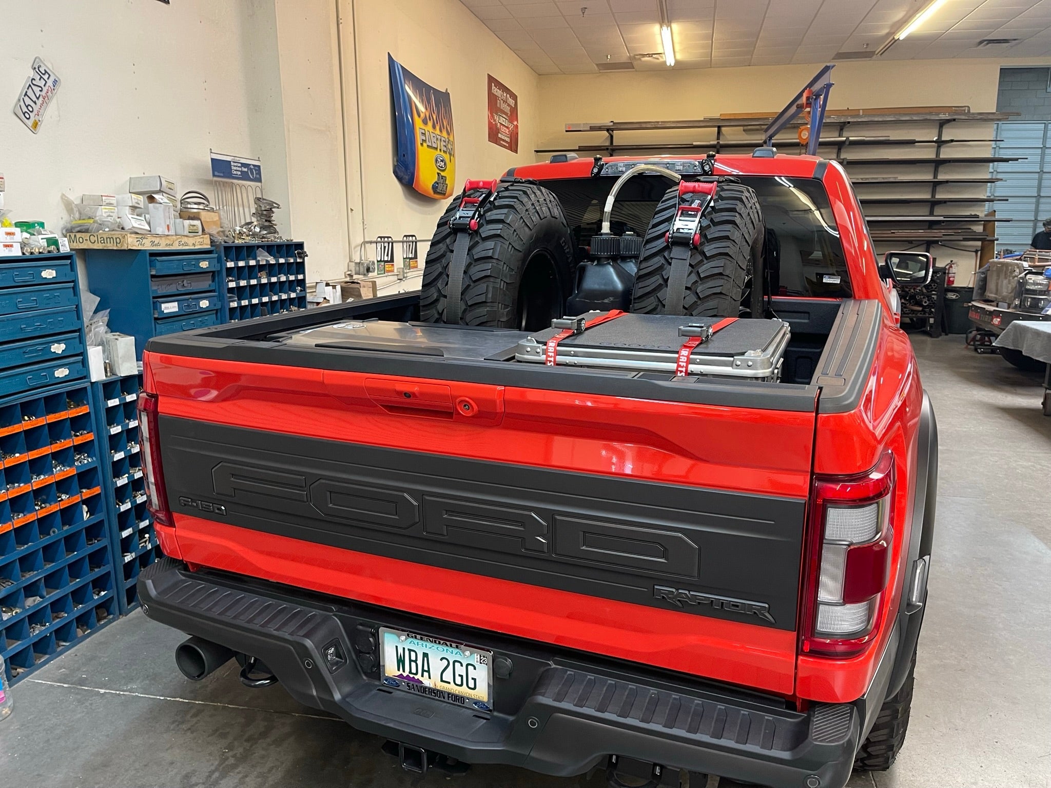 2017-2024 Raptor rear bed organizer with ADD on rear cargo slide tray, featuring mounted tires in a truck bed.