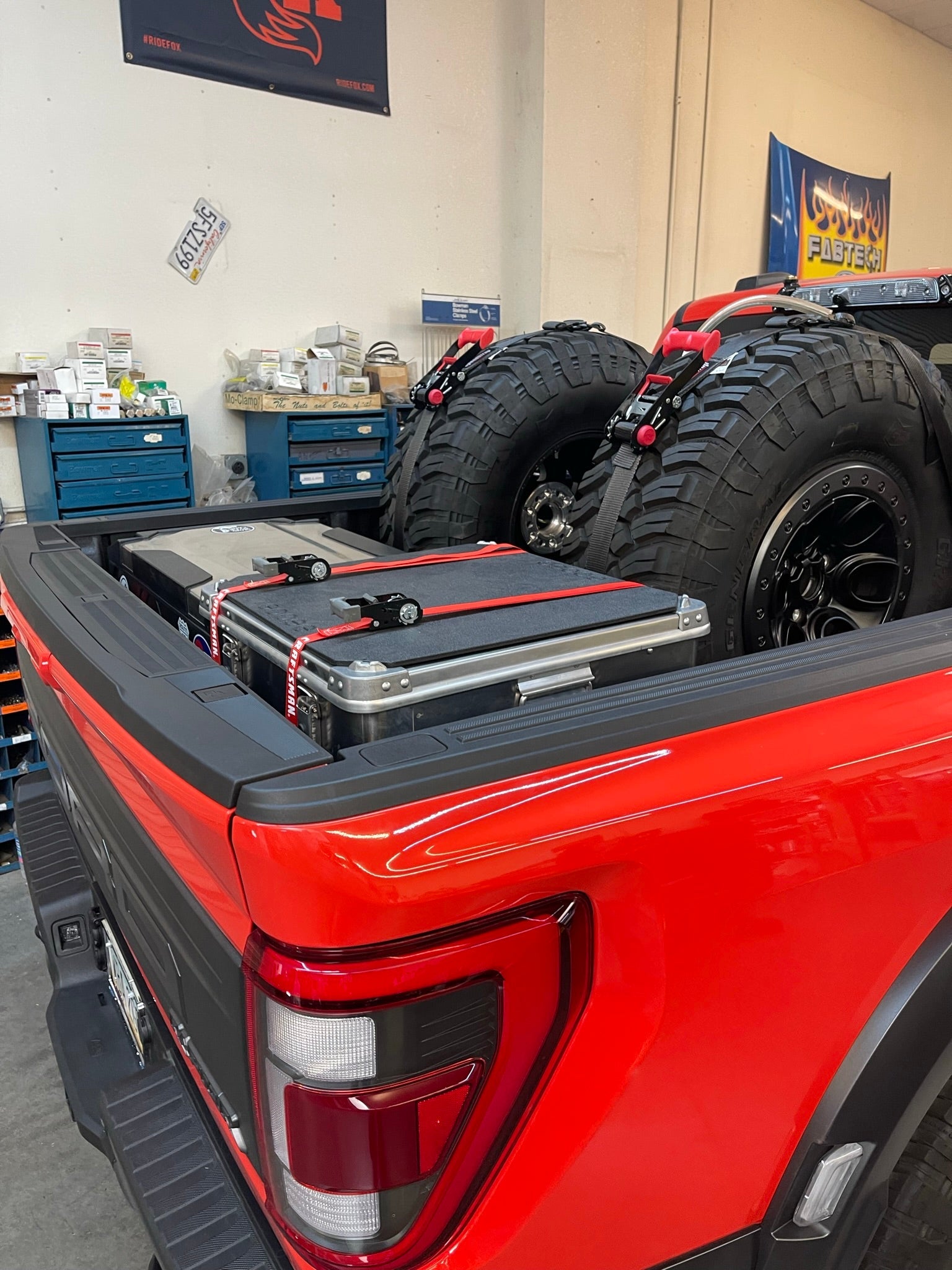 Rear view of a 2017-2024 Raptor with a bed organizer and cargo slide tray, showcasing organized storage for offroad gear.