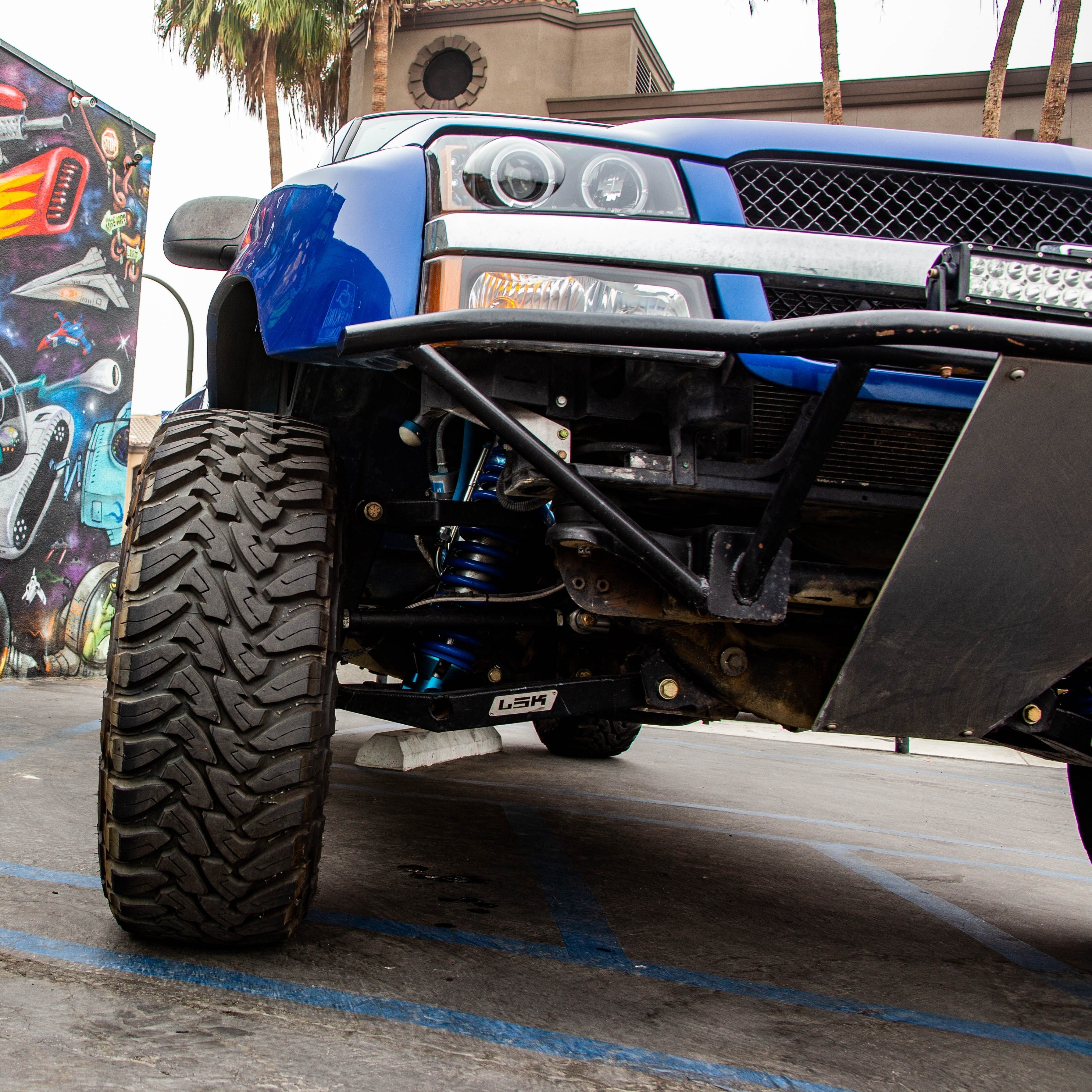 2003-2006 Chevrolet Silverado fenders showcasing a lifted truck with offroad tires and suspension components.