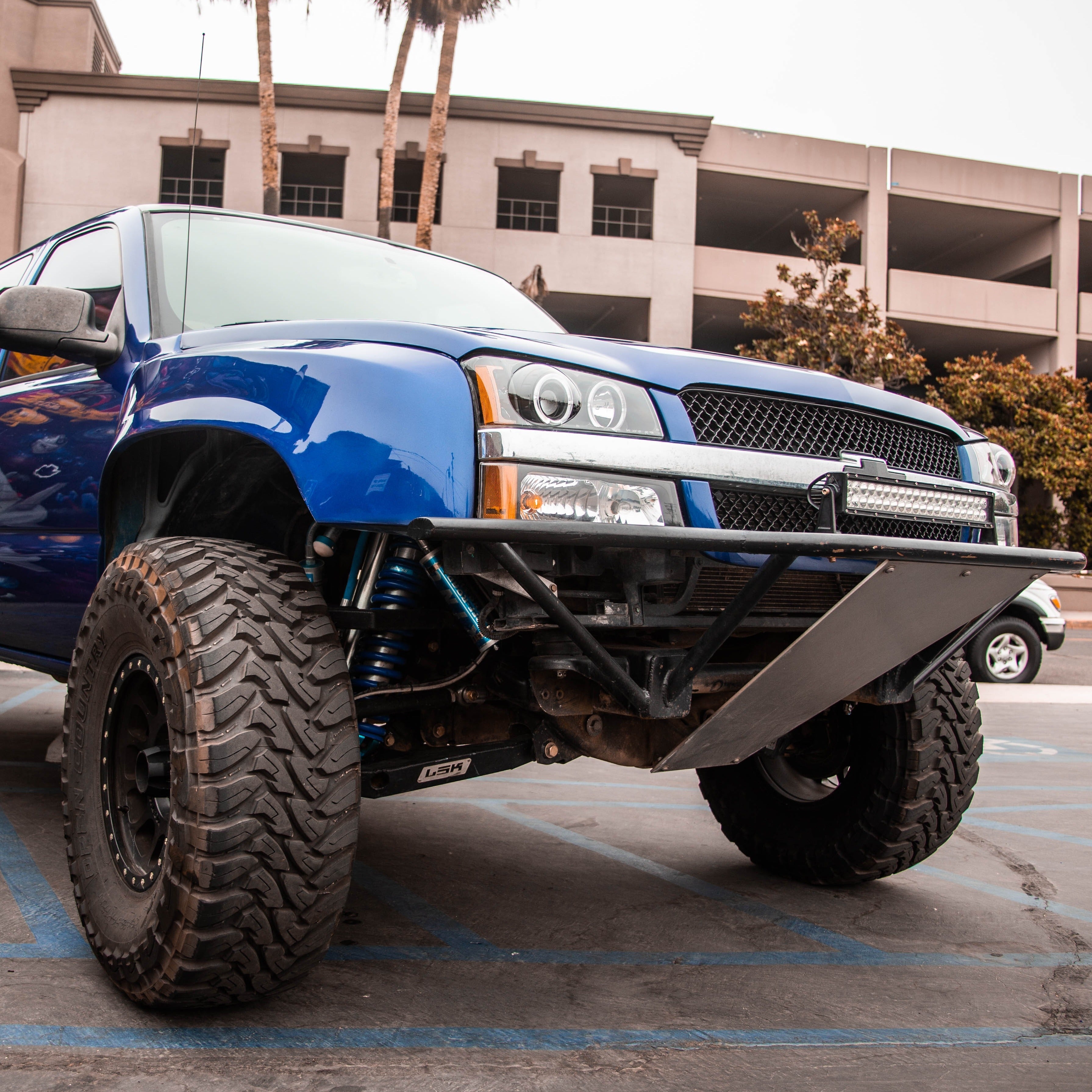 2003-2006 Chevrolet Silverado fenders showcasing a rugged offroad truck with a bold front bumper and large tires.