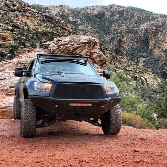 2007-2013 Toyota Tundra fenders showcased on an offroad truck in a rugged landscape, highlighting durability and style.