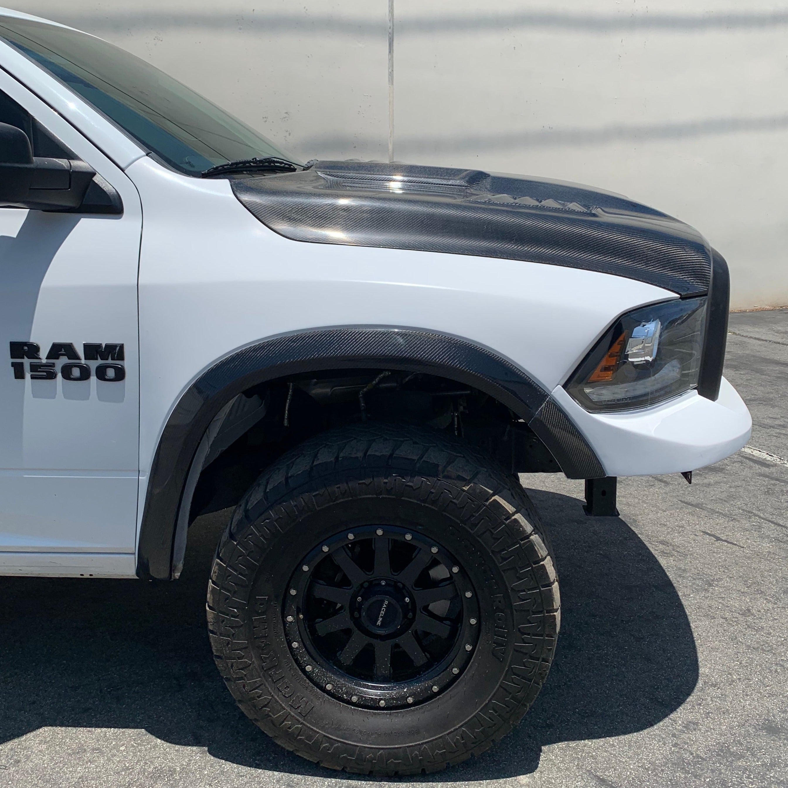 2009-2018 Dodge Ram TRX Kit showcasing a modified truck with a carbon fiber hood and off-road tires.
