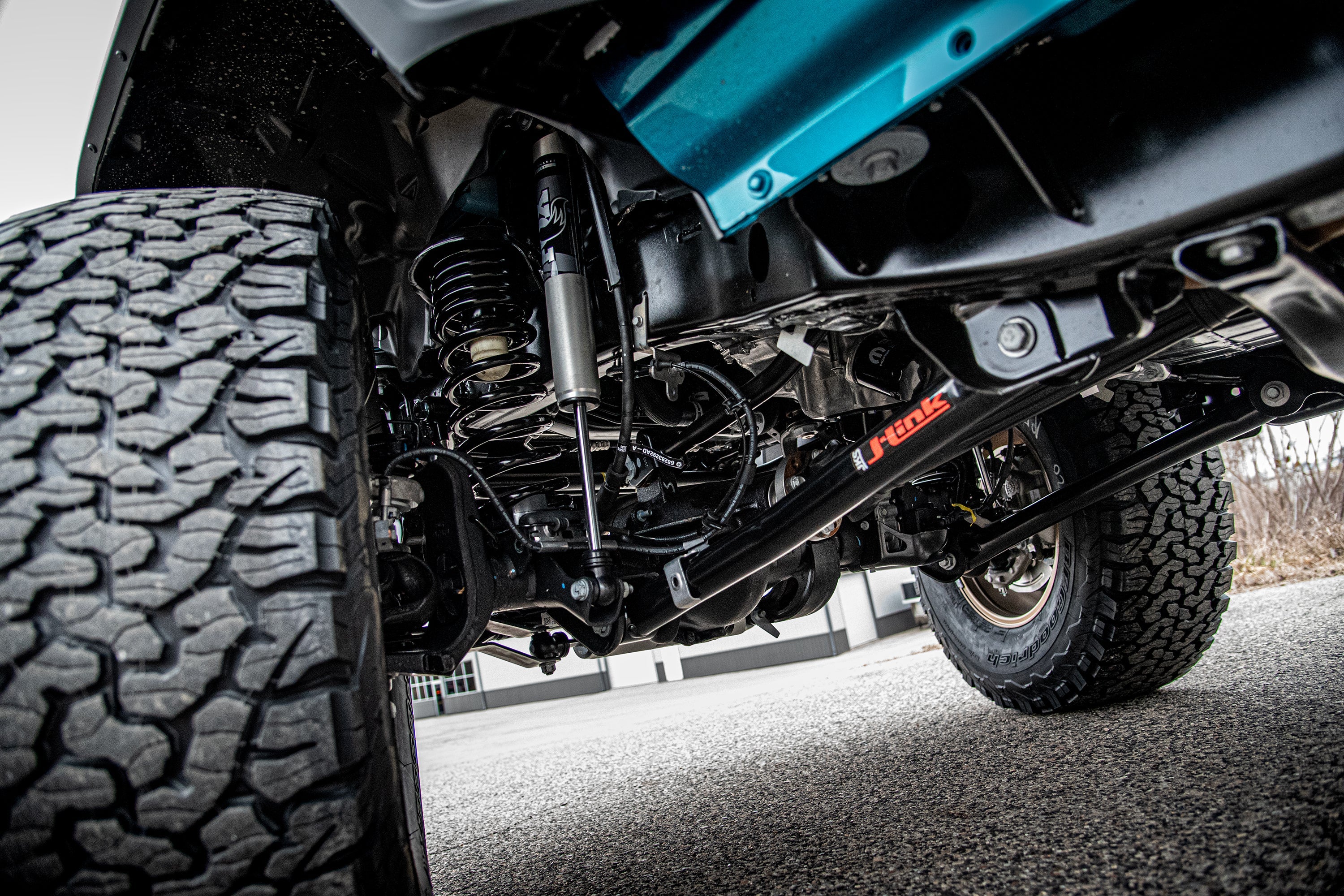 3.5-inch lift kit for Wrangler JL RHD 4-Door, showcasing suspension components and rugged tires for off-road performance.