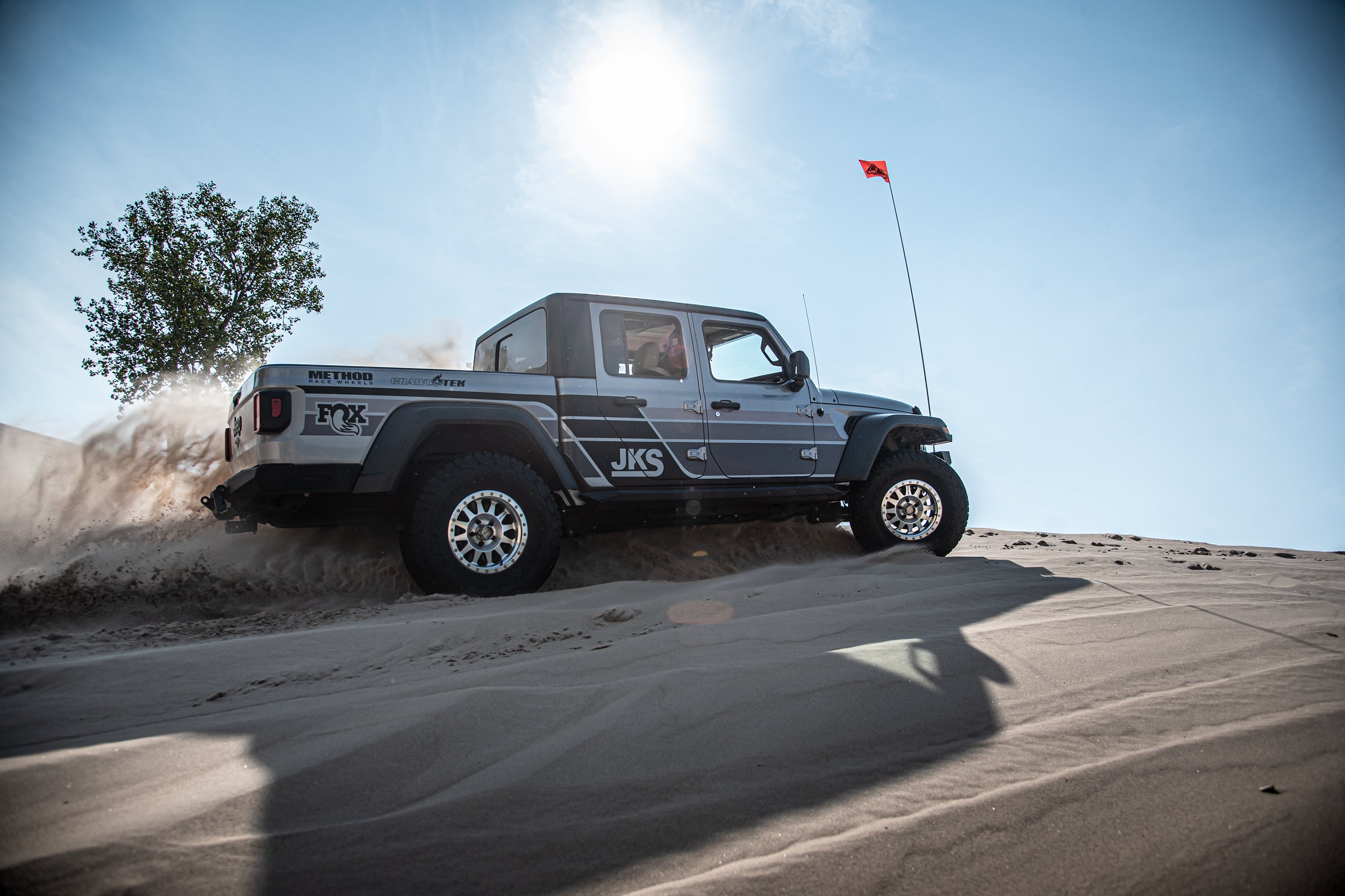 3.5-inch lift kit for Gladiator JT installed on a truck driving through sandy terrain, showcasing offroad capability.