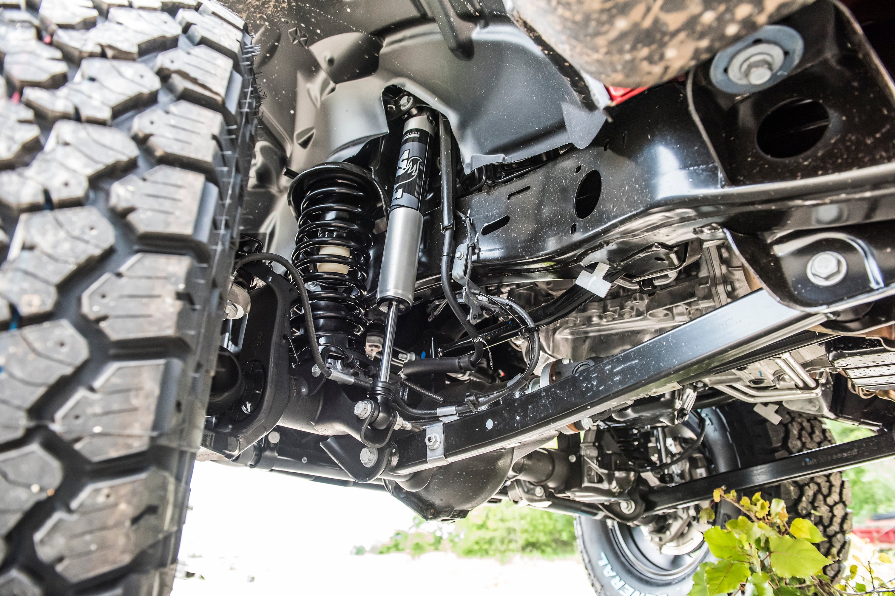 Close-up of a 2-inch lift kit installed on a Jeep Gladiator JT, showcasing suspension components and undercarriage details.