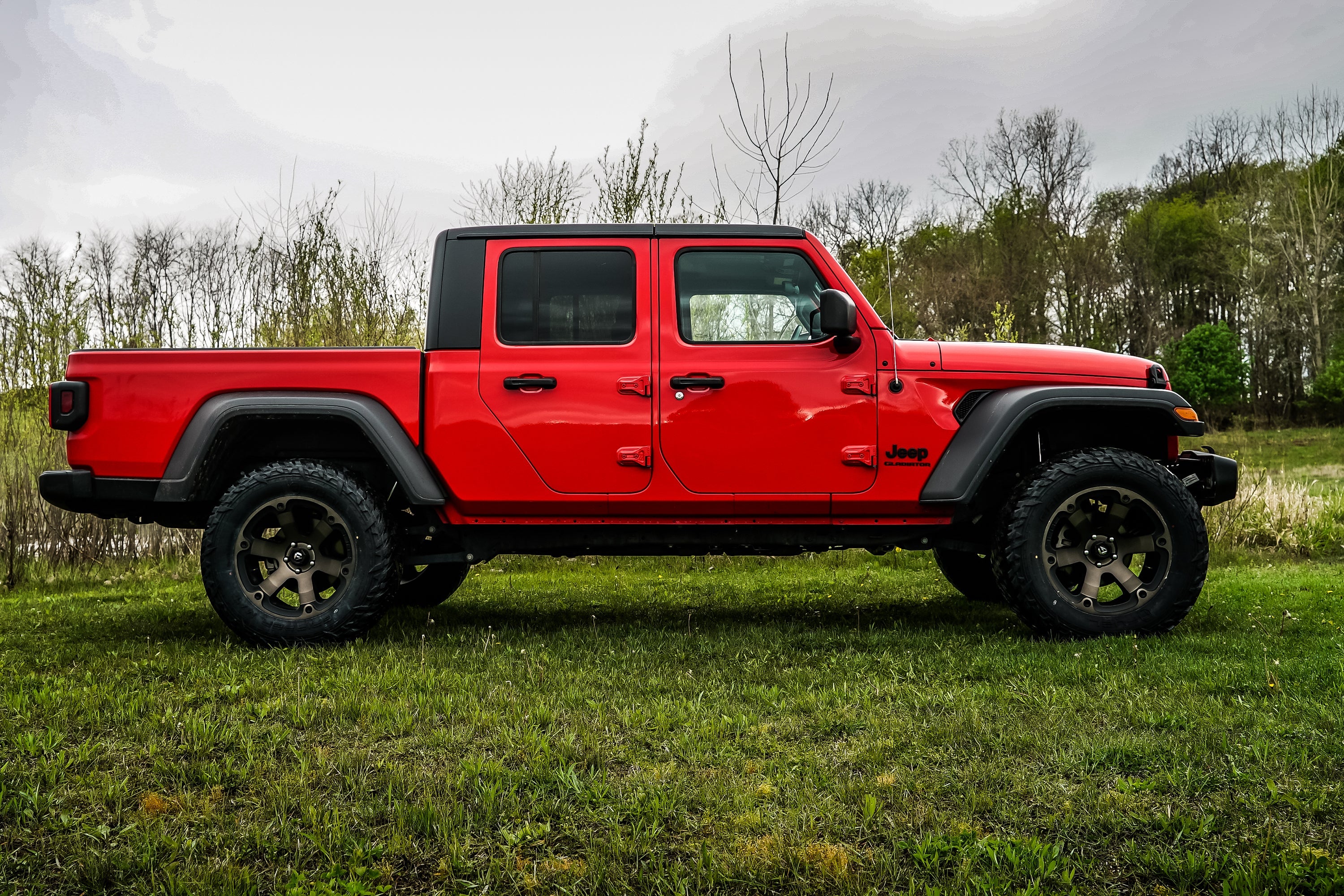 3-inch lift kit for Jeep Gladiator JT (2020-2025) showcased on a red Jeep with off-road tires in a natural setting.