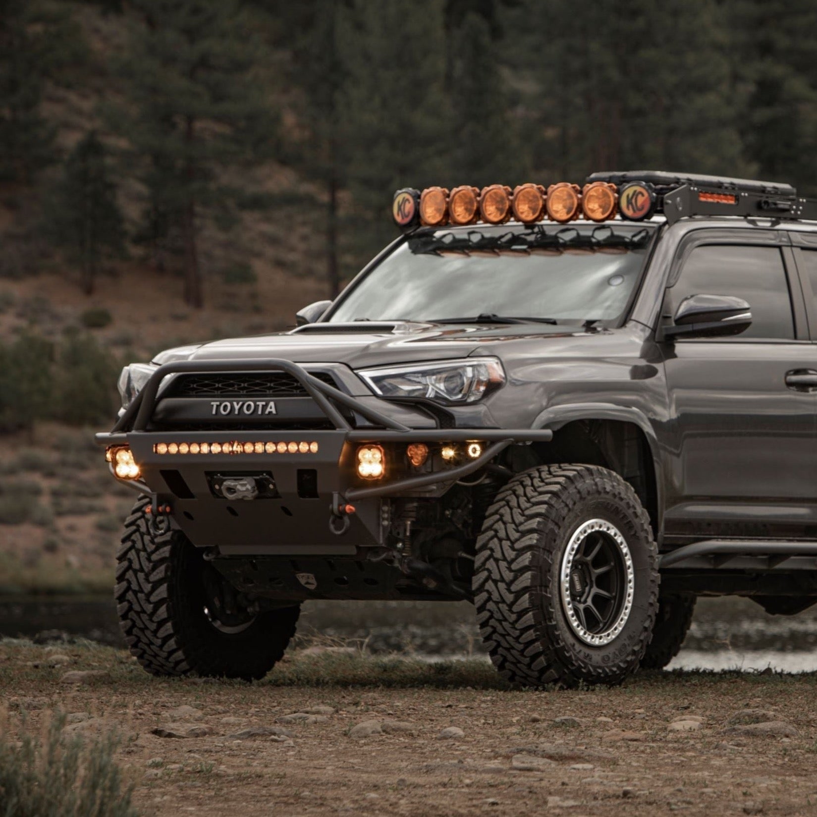 4Runner Hybrid Front Bumper for 5th Gen models (2014-2024) installed on a Toyota 4Runner with off-road lights and rugged tires.