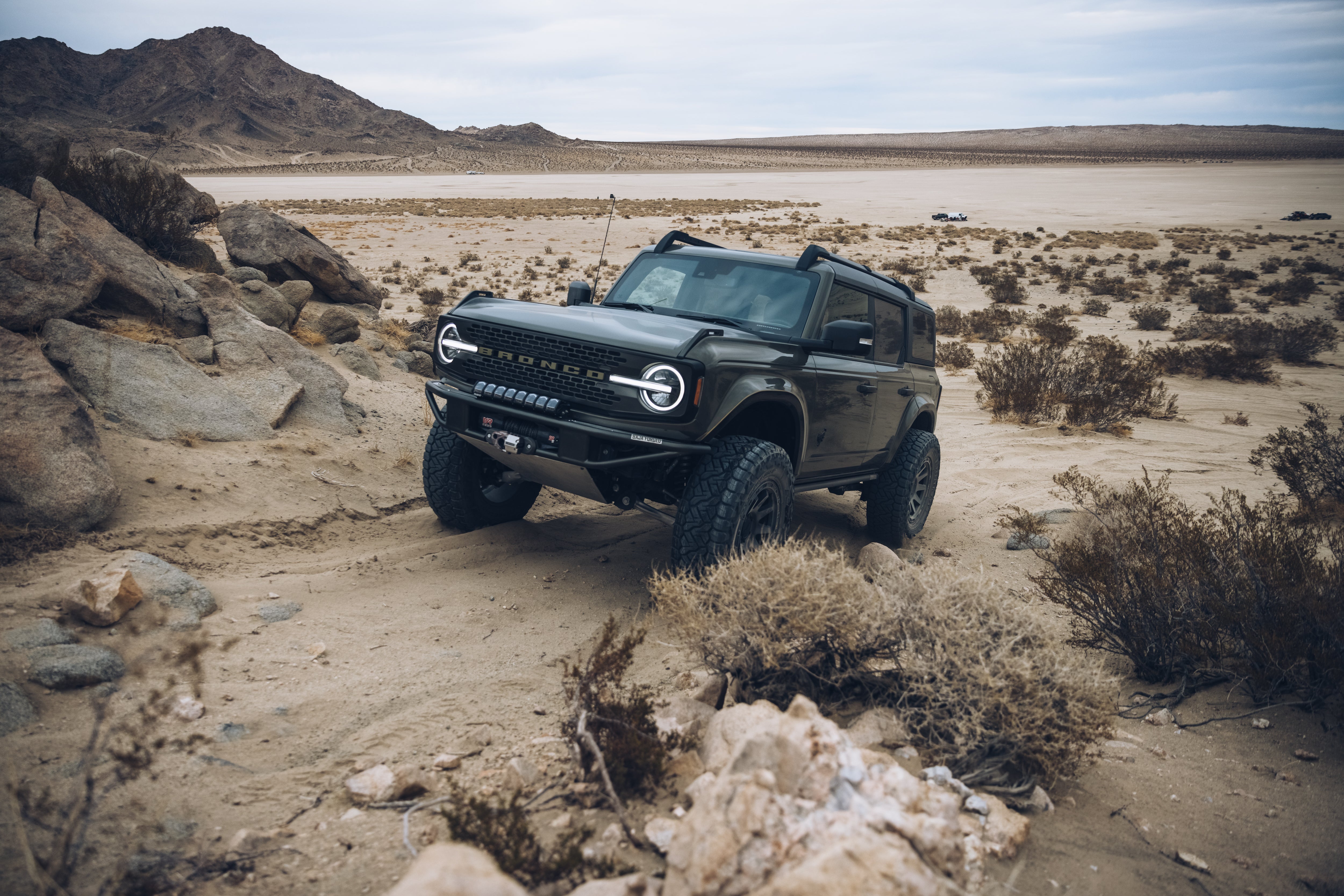 2021 Outer Banks Bronco with BAJA FORGED accessories navigating a rugged desert landscape.