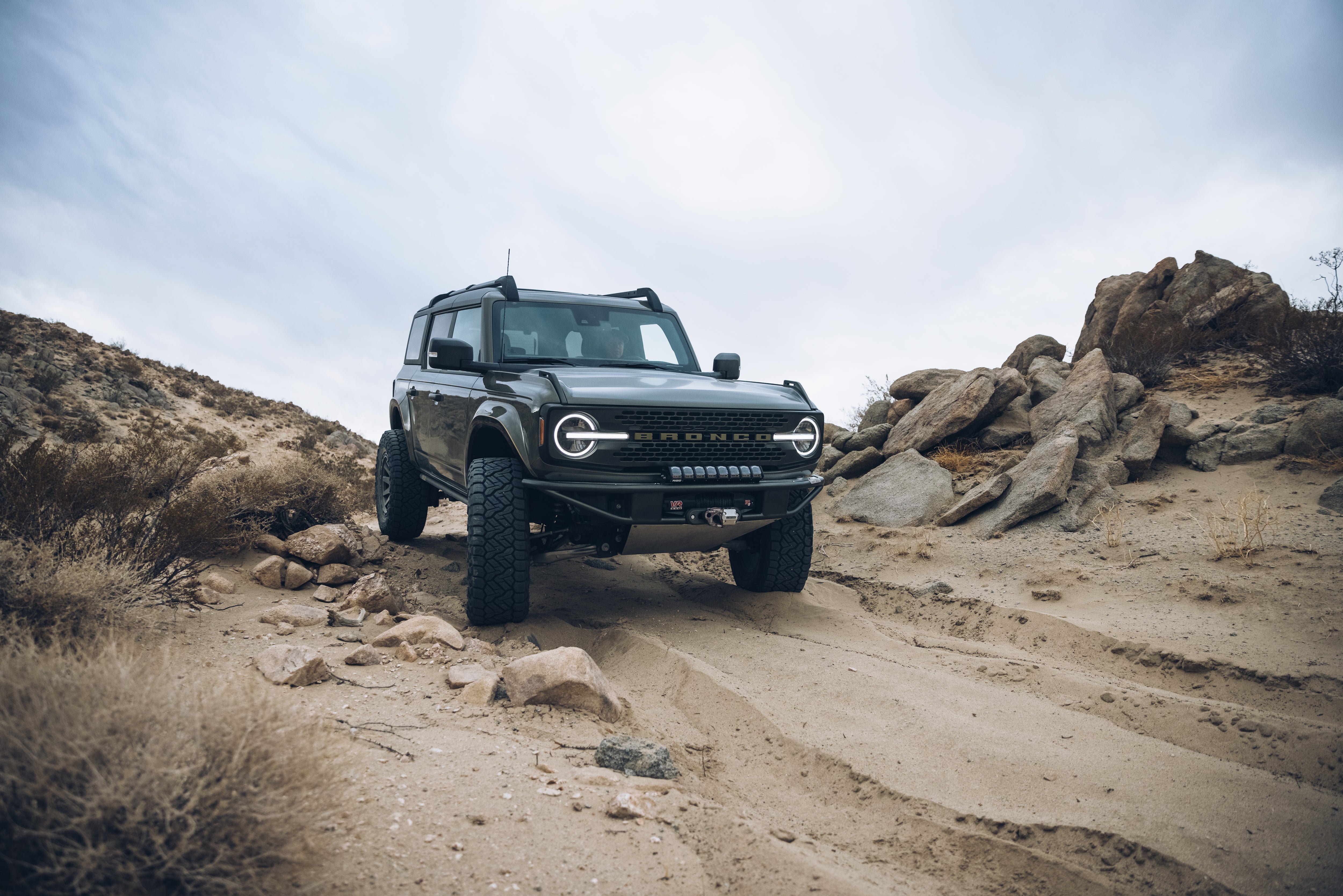 2021 Outer Banks Bronco with BAJA FORGED accessories on rugged terrain, showcasing offroad capabilities and style.