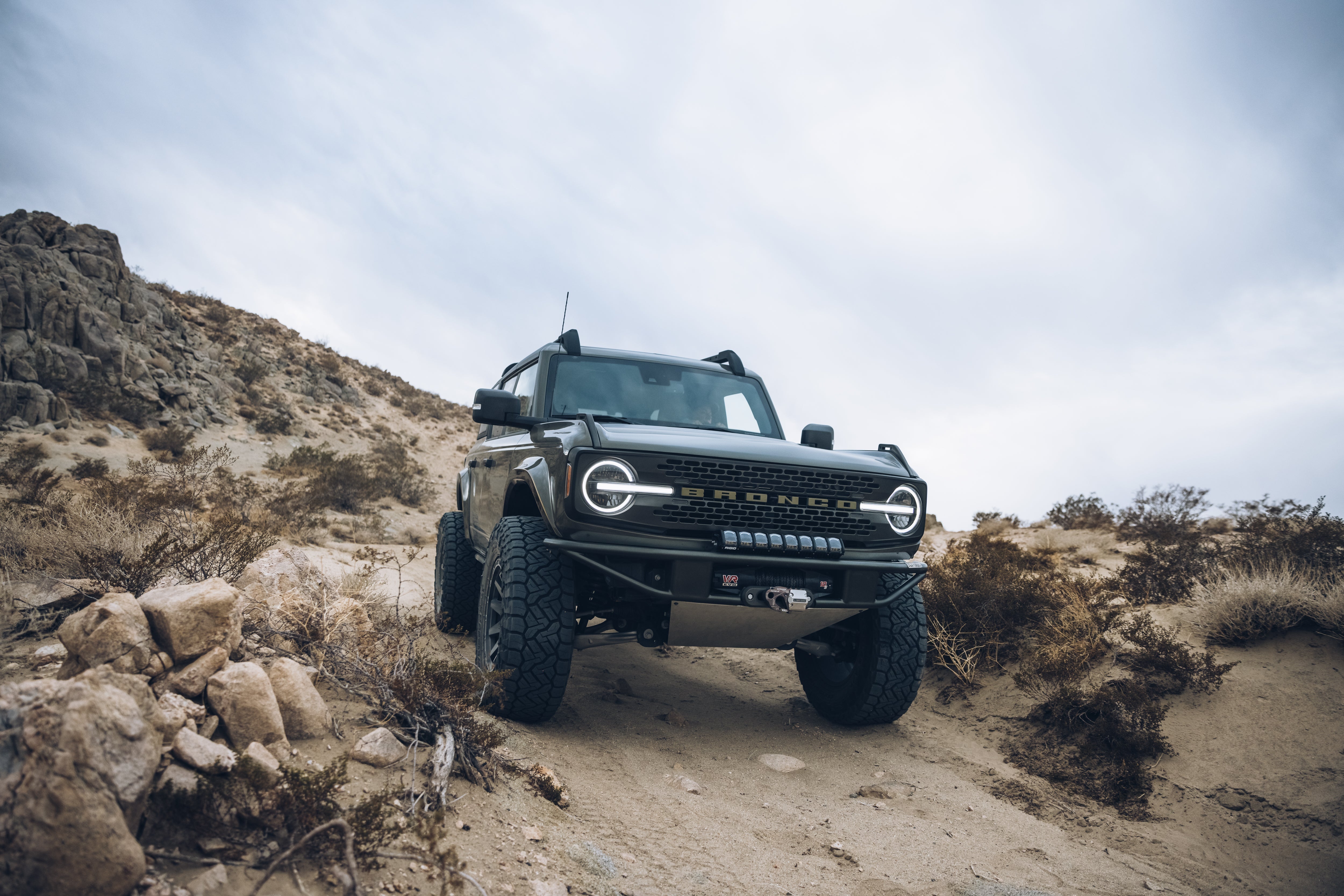 2021 Outer Banks Bronco with BAJA FORGED accessories on rugged terrain, showcasing offroad capabilities and style.