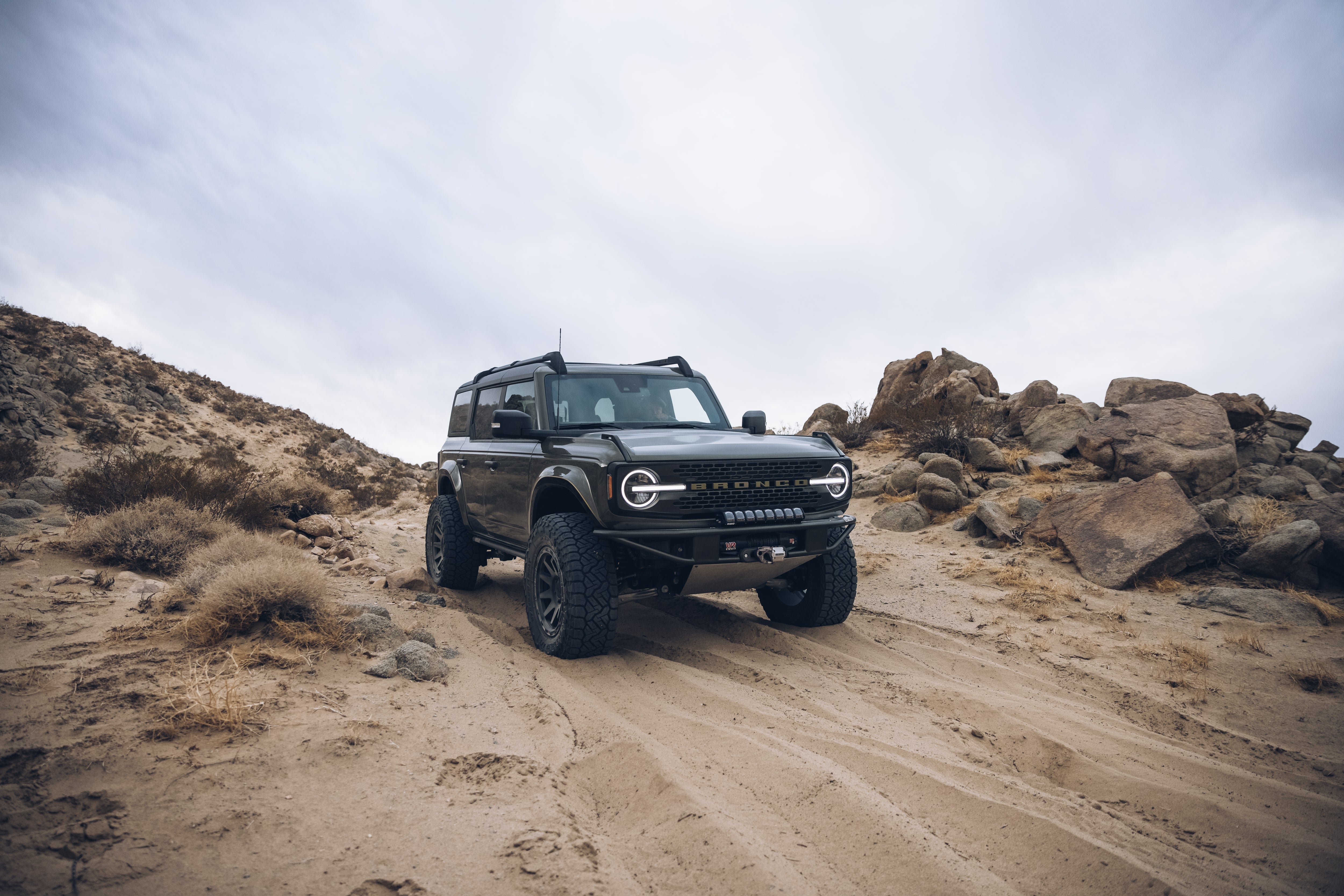 2021 Outer Banks Bronco with BAJA FORGED accessories on rugged terrain, showcasing off-road capability and style.