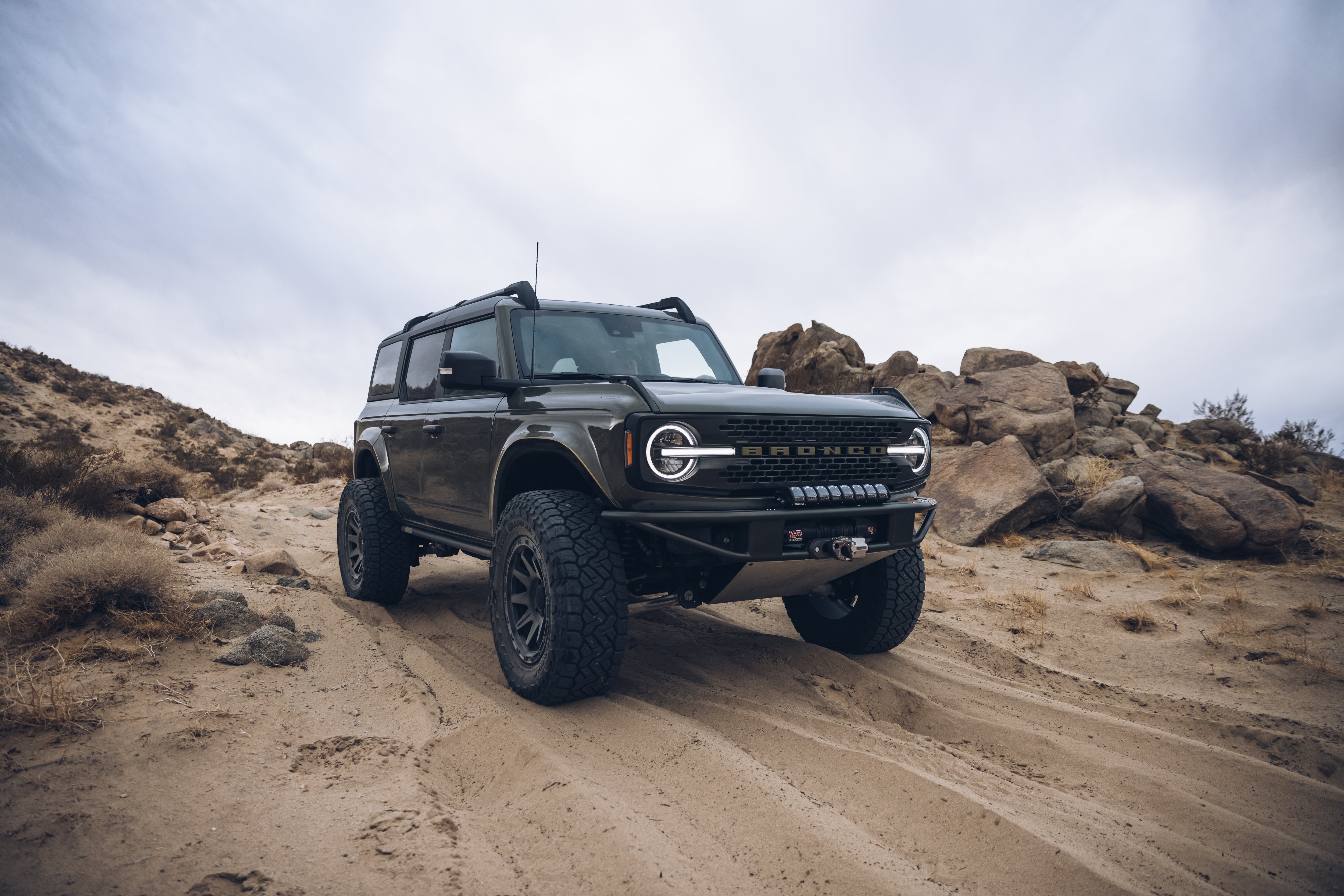 2021 Outer Banks Bronco with BAJA FORGED accessories on rugged terrain, showcasing offroad capabilities and style.