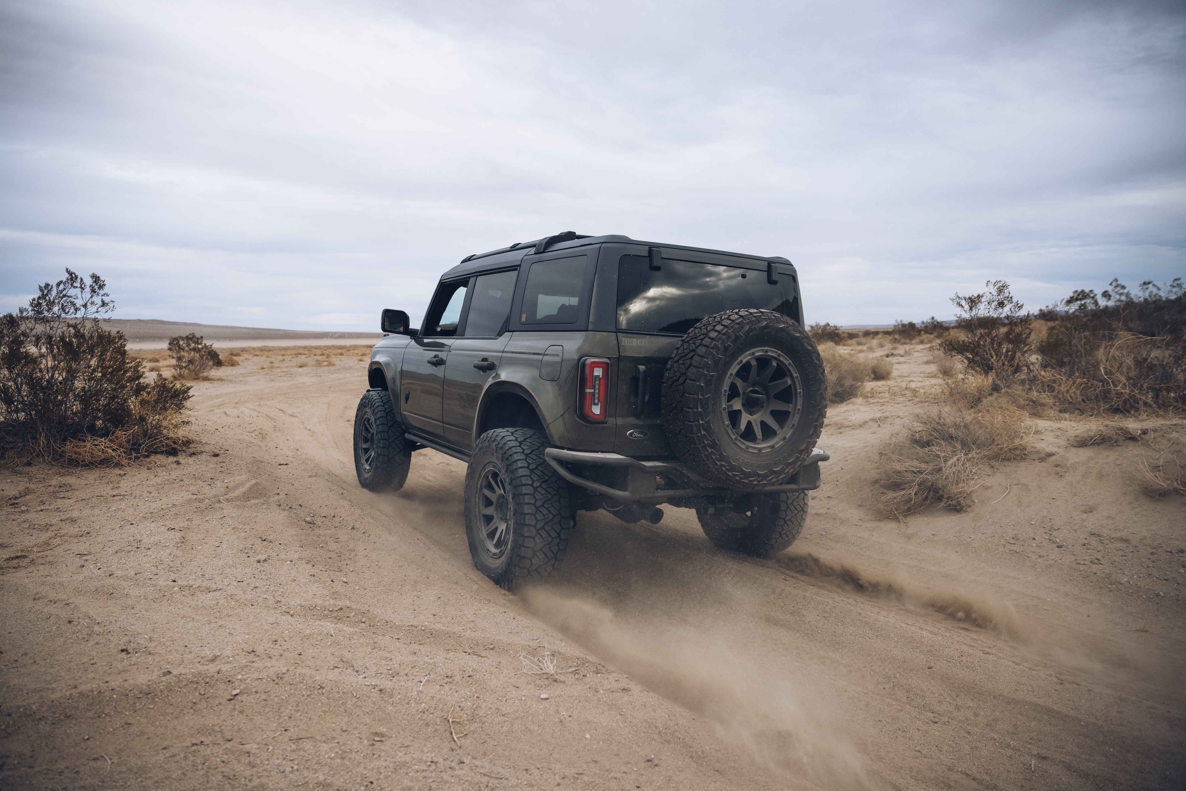 2021 Outer Banks BAJA FORGED off-road vehicle navigating a sandy trail, showcasing rugged design and performance.