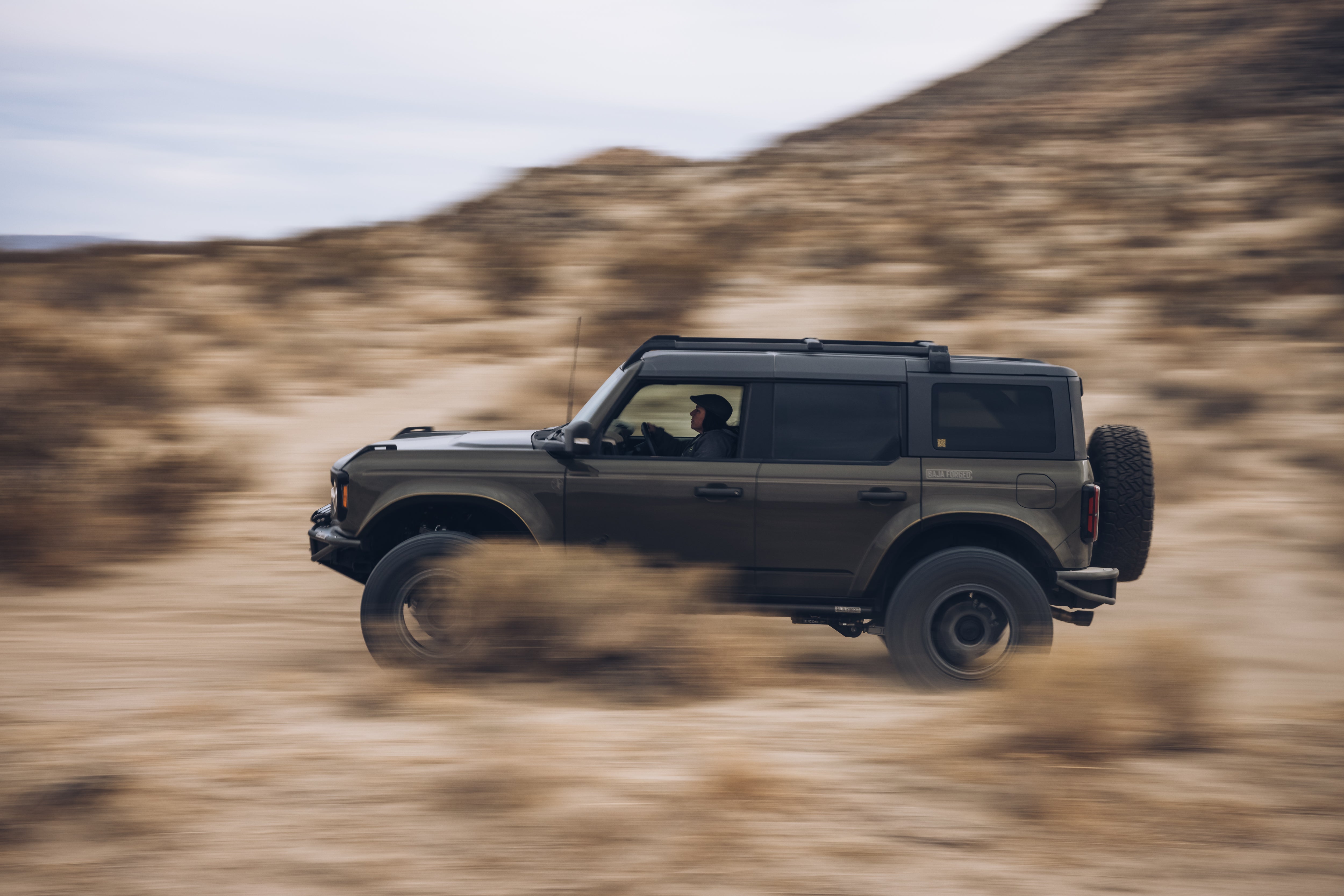 2021 Outer Banks BAJA FORGED SUV driving through sandy terrain, showcasing offroad capabilities and rugged design.