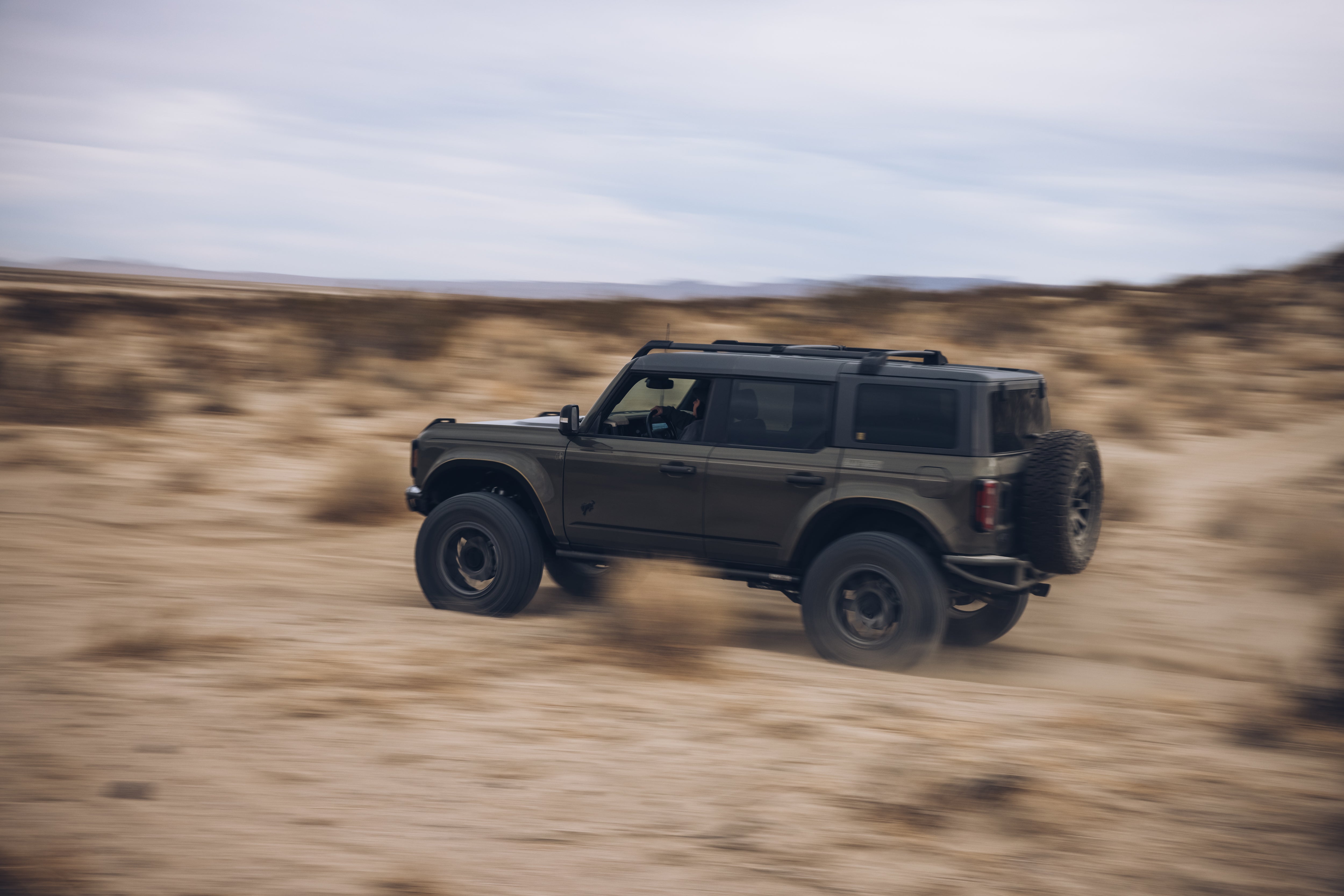 2021 Outer Banks BAJA FORGED off-road vehicle navigating through sandy terrain, showcasing rugged design and performance.