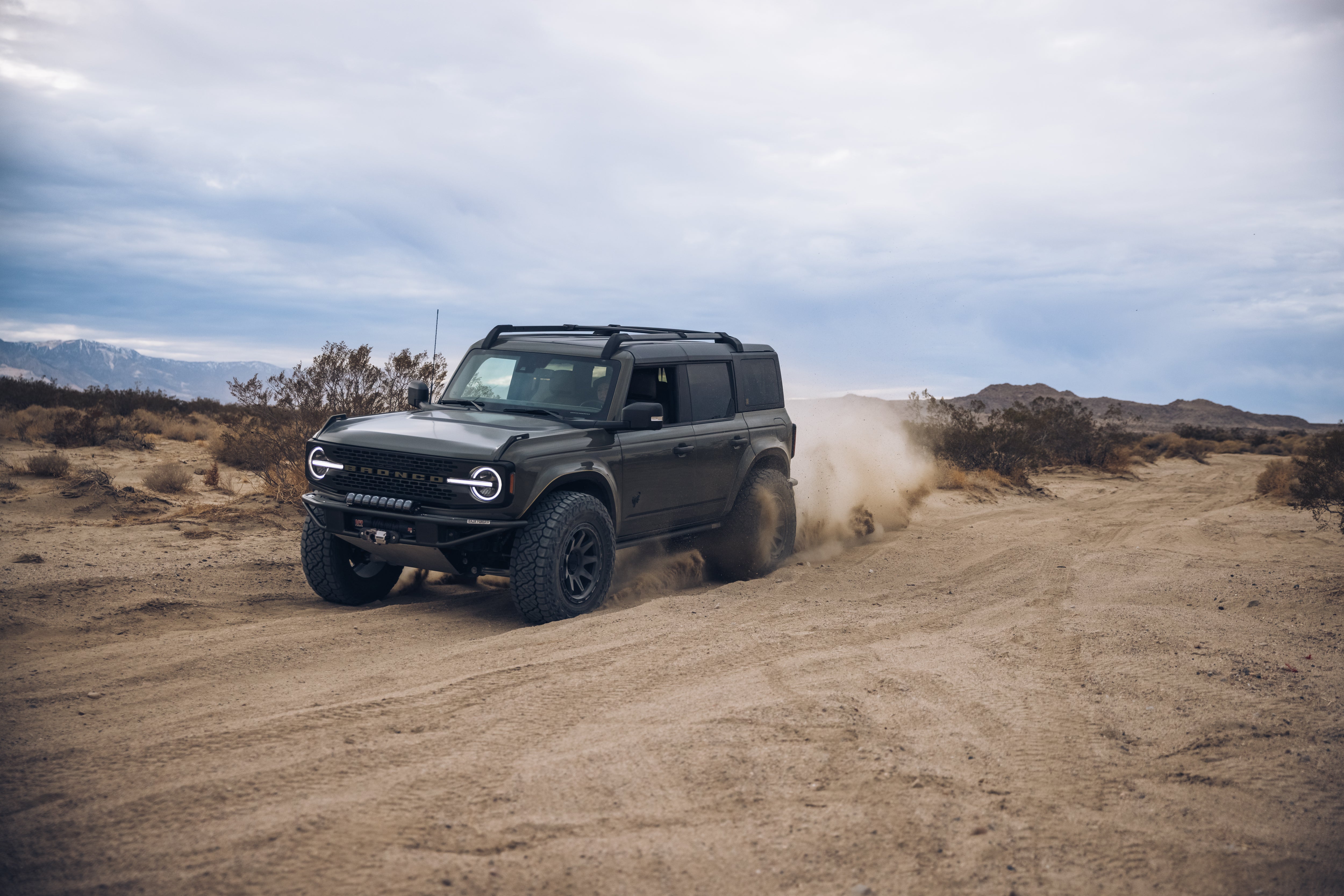 2021 Outer Banks BAJA FORGED off-road vehicle driving through sandy terrain, showcasing rugged design and performance.