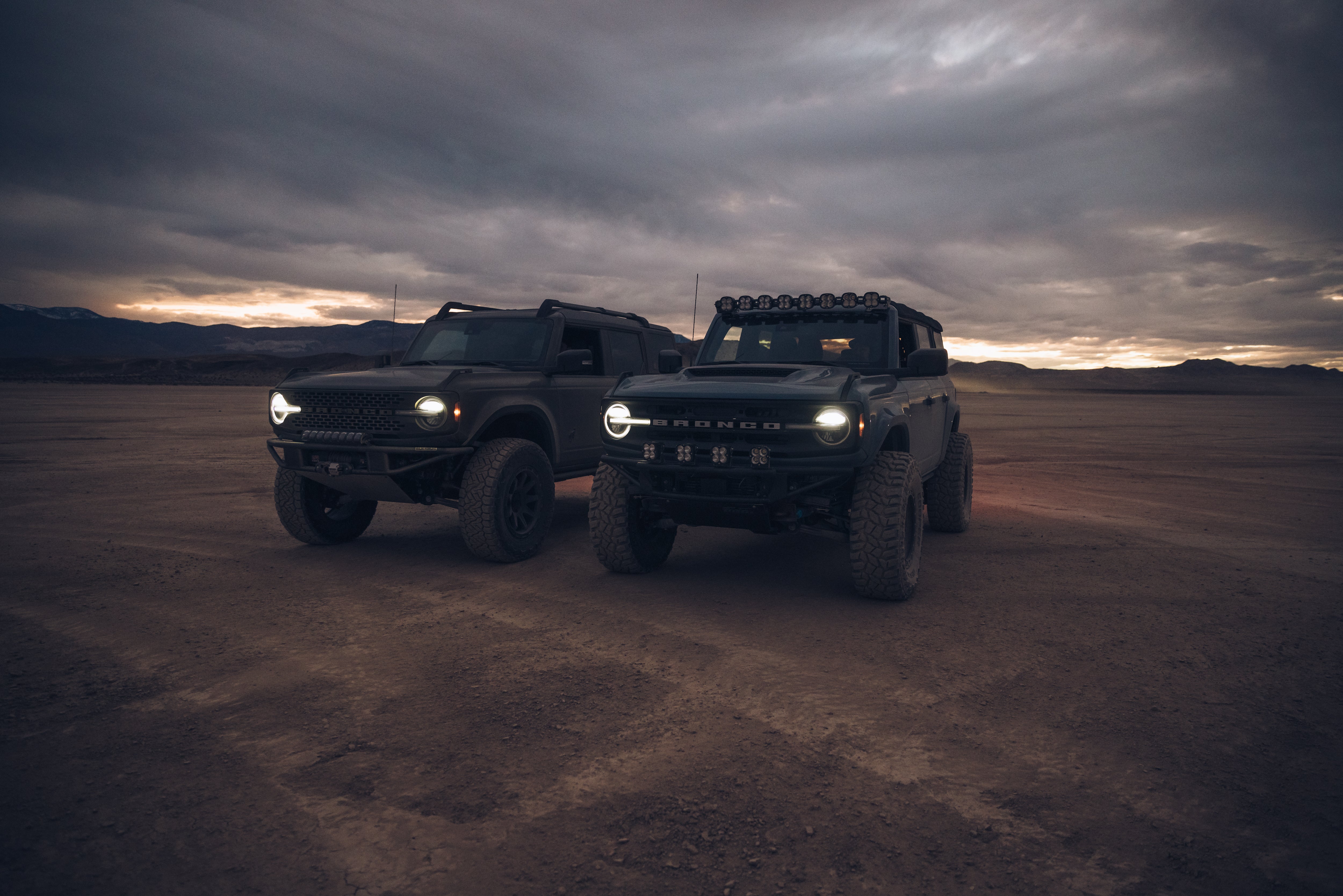 ADV Fiberglass 2021 Ford vehicles showcasing rugged off-road design in a dramatic desert landscape at sunset.