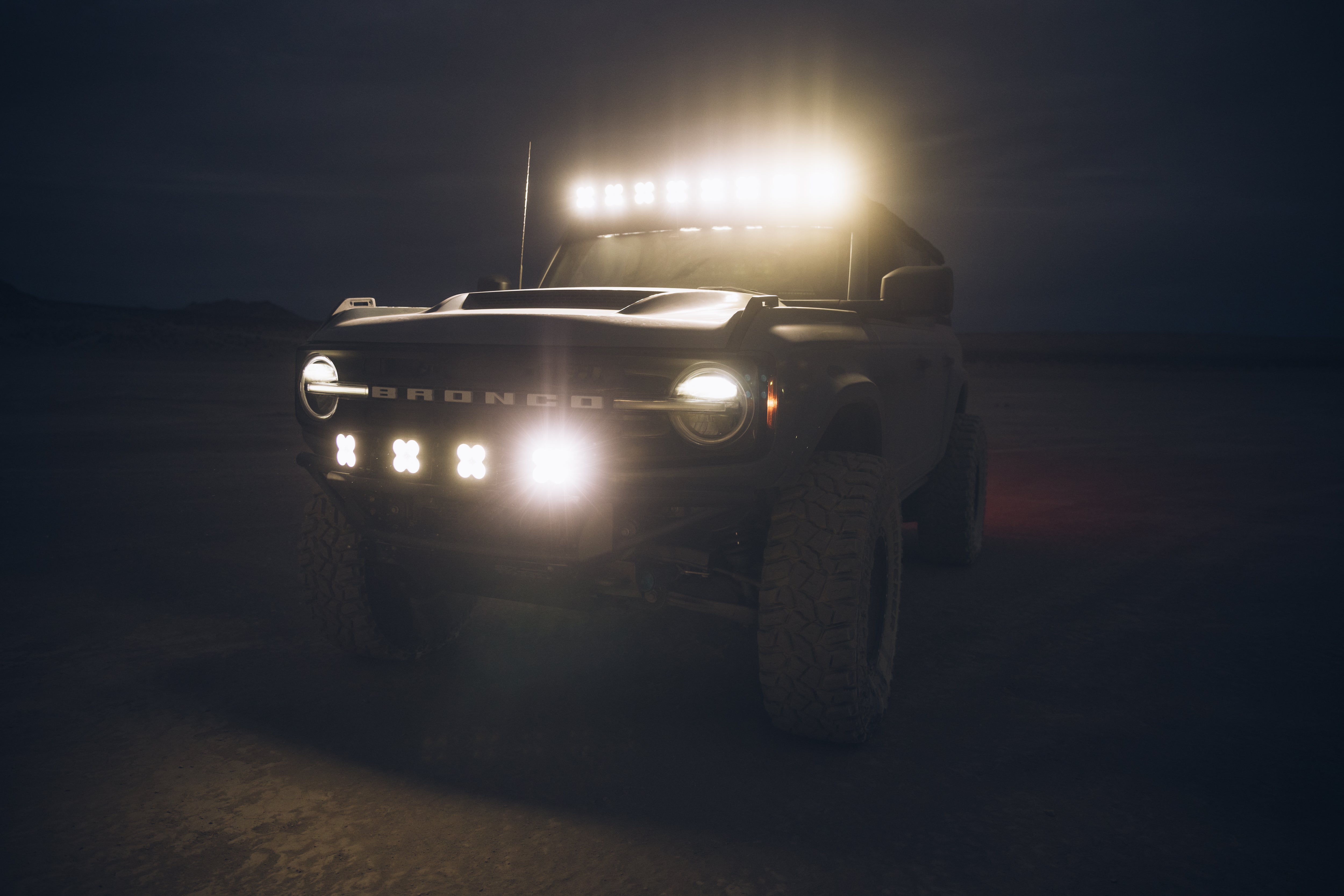 ADV Fiberglass 2021 Ford Bronco with off-road lights, showcasing rugged design and enhanced visibility in low light.