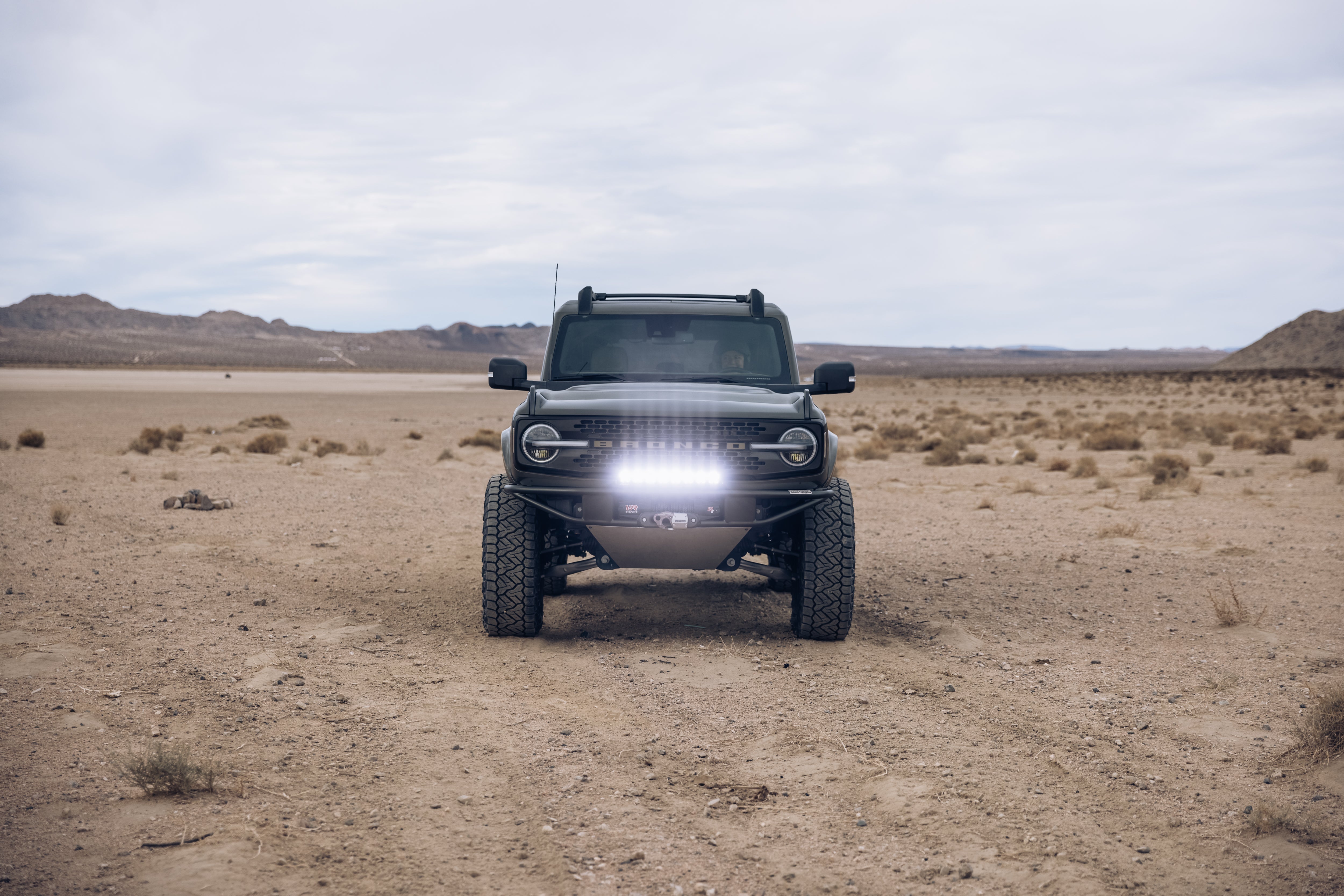 2021 Outer Banks Bronco with BAJA FORGED accessories in a desert landscape, showcasing offroad capabilities and rugged design.