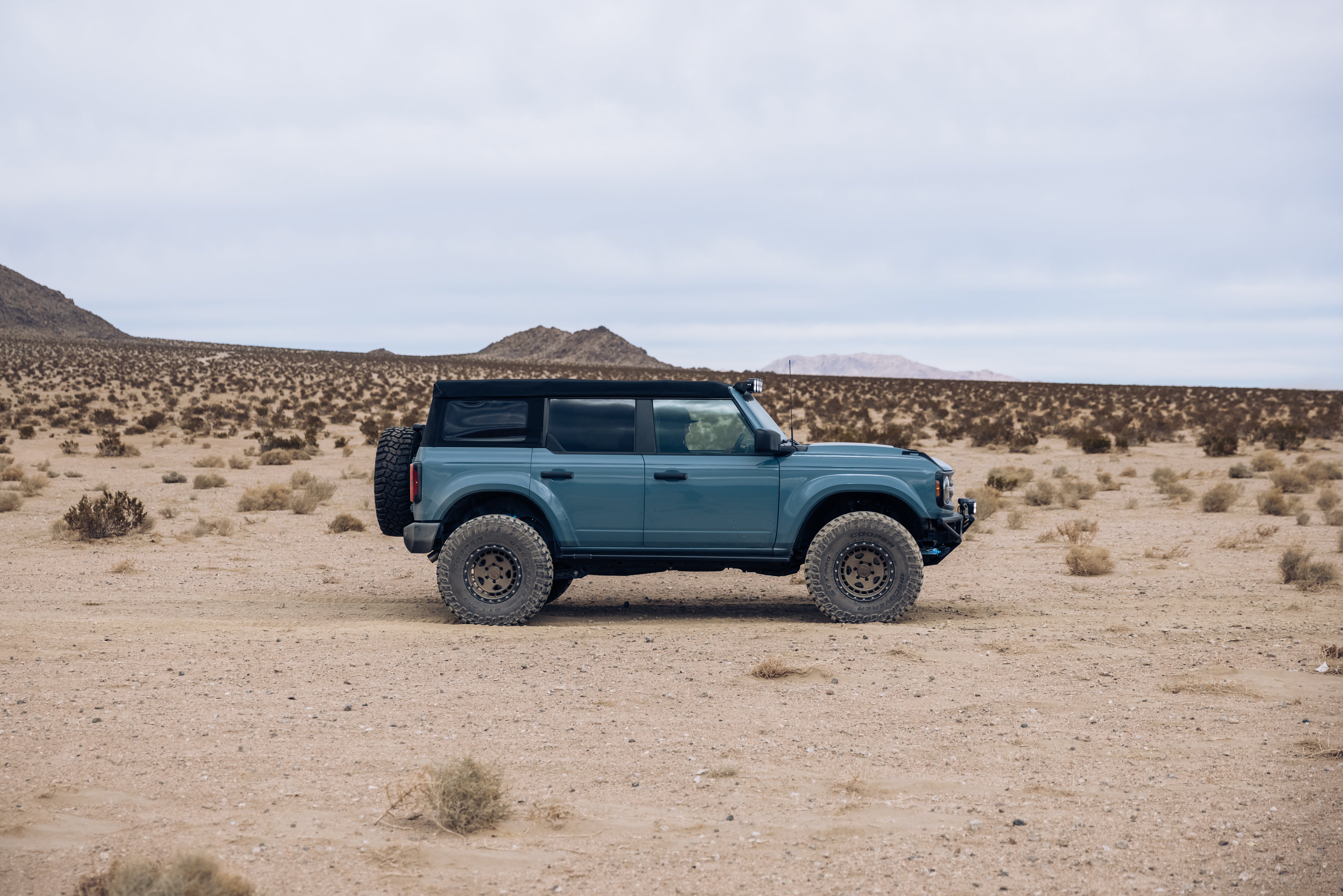 ADV Fiberglass 2021 Ford SUV parked in a desert landscape, showcasing offroad capabilities and rugged design.