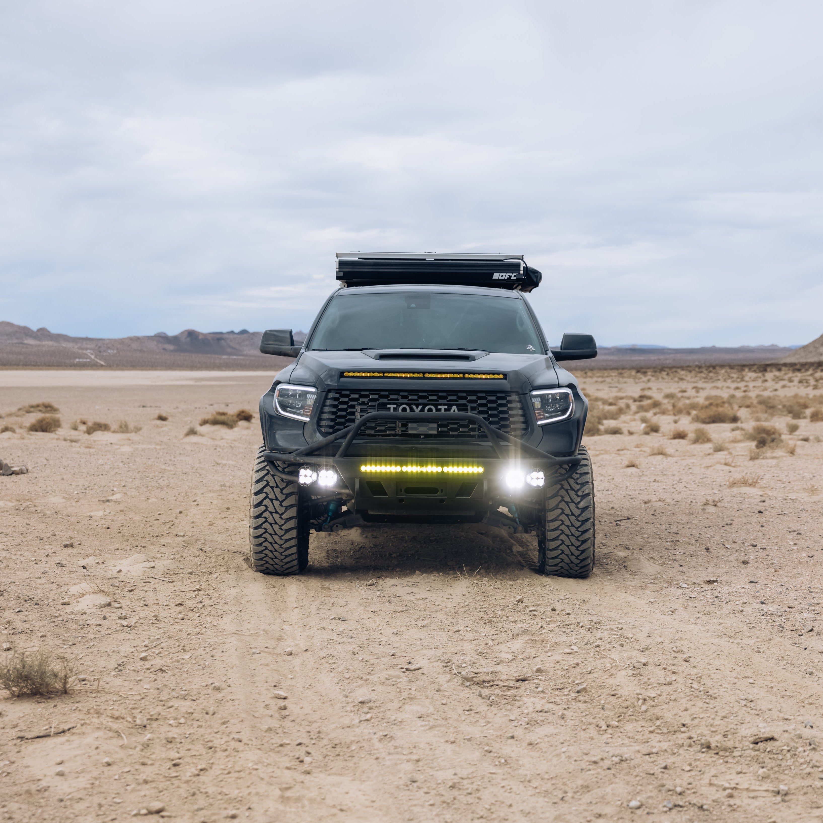 2014-2021 Toyota Tundra fenders showcased on an offroad truck in a desert landscape, highlighting durability and style.