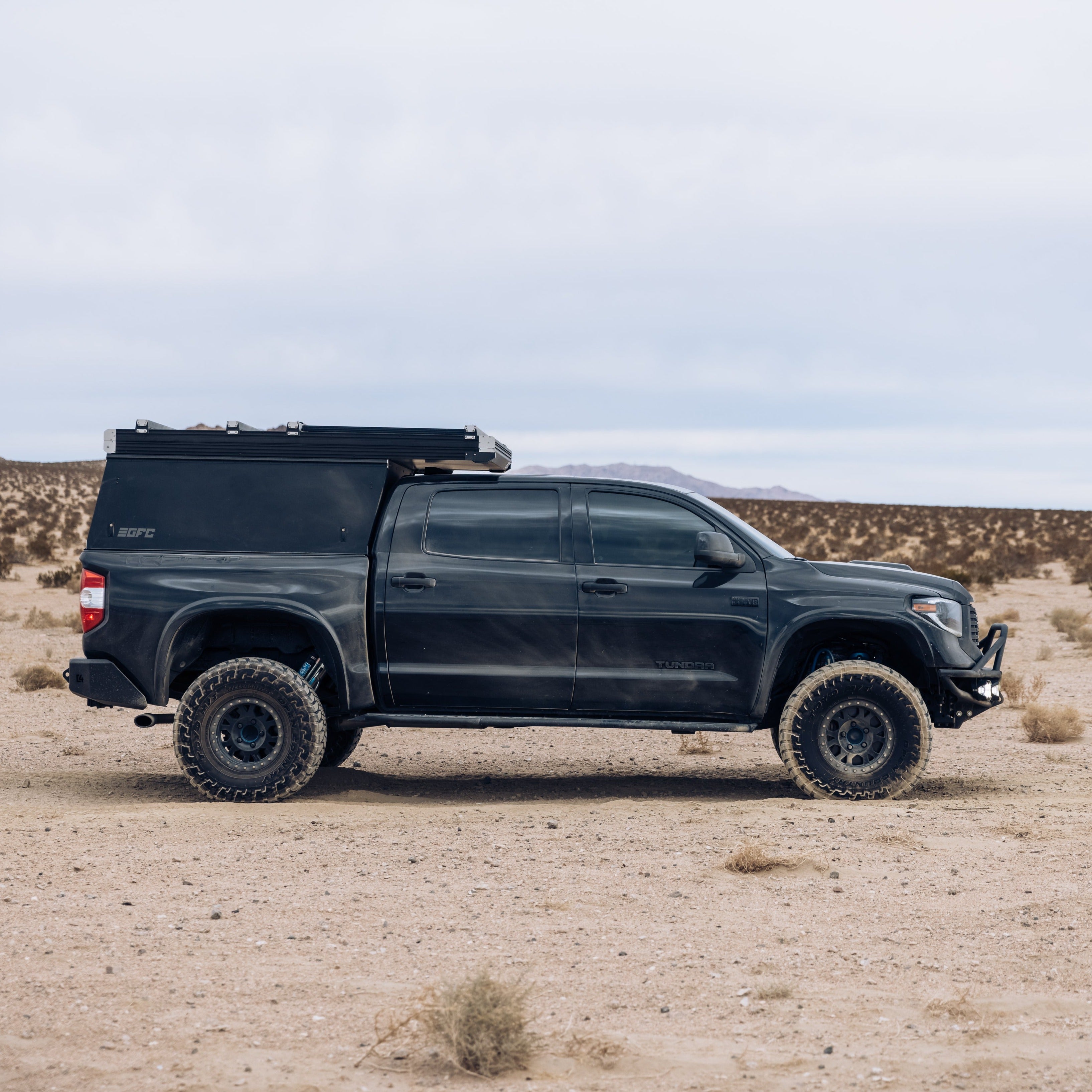 2014-2021 Toyota Tundra with custom bedsides, showcasing off-road capabilities in a desert landscape.