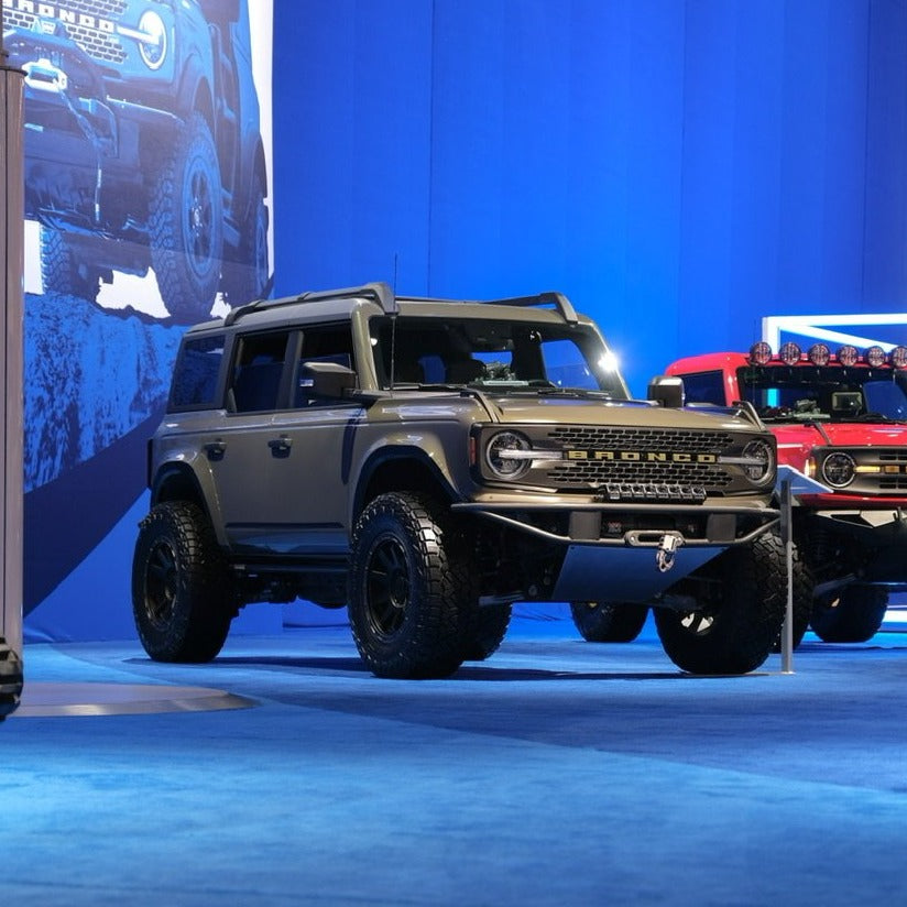2021-2025 Ford Bronco fenders displayed on a modified Bronco at an automotive event, showcasing rugged design and off-road capability.