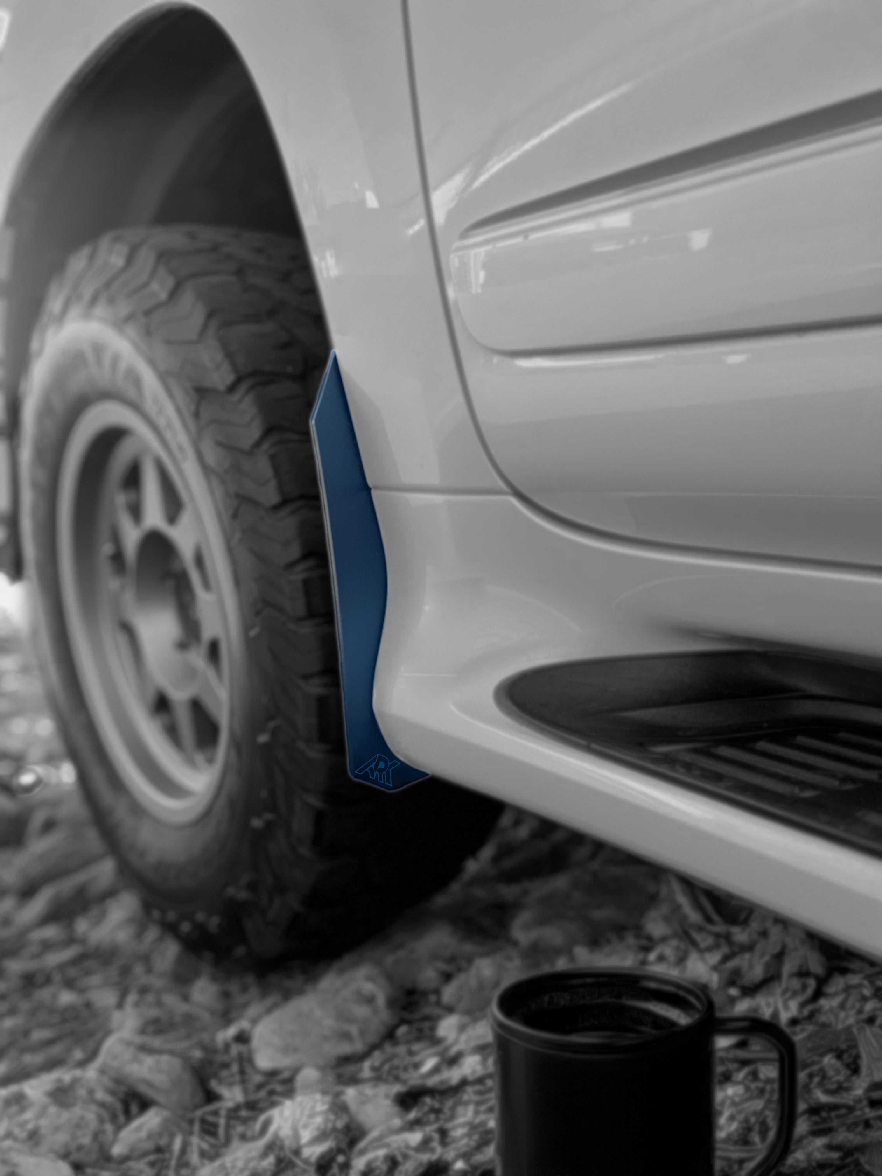 Lexus GX 460 with TriXpoly Micro Flare MudFlap Deletes, showcasing a sleek design and rugged tire on rocky terrain.