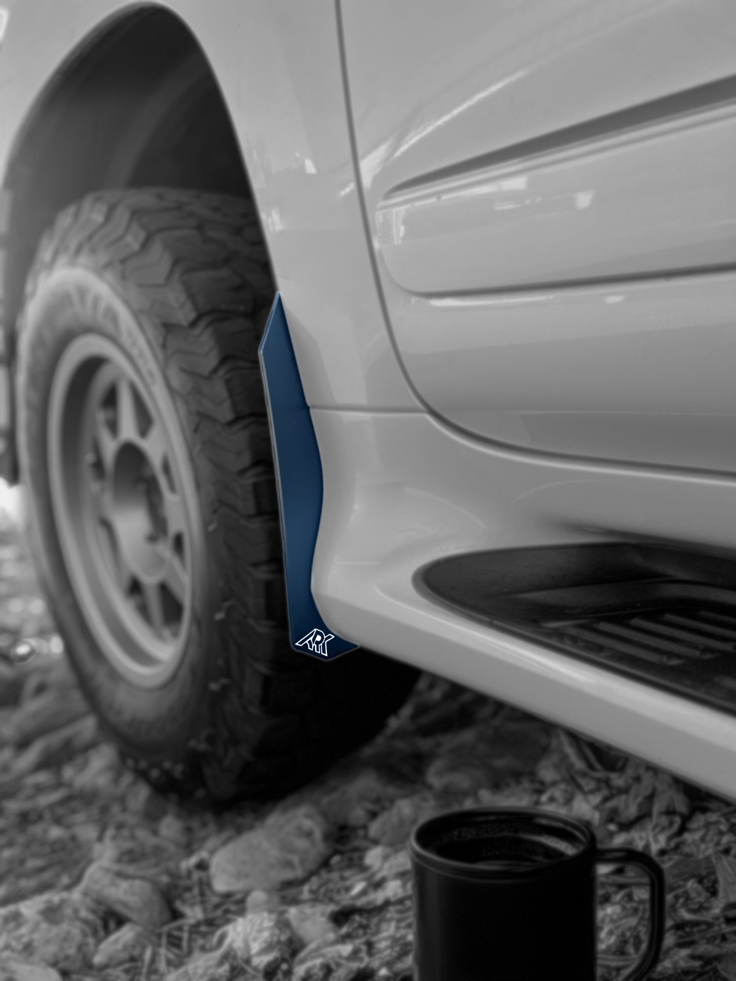 Lexus GX 460 with TriXpoly Micro Flare MudFlap Deletes showcasing sleek design and rugged tire on rocky terrain.
