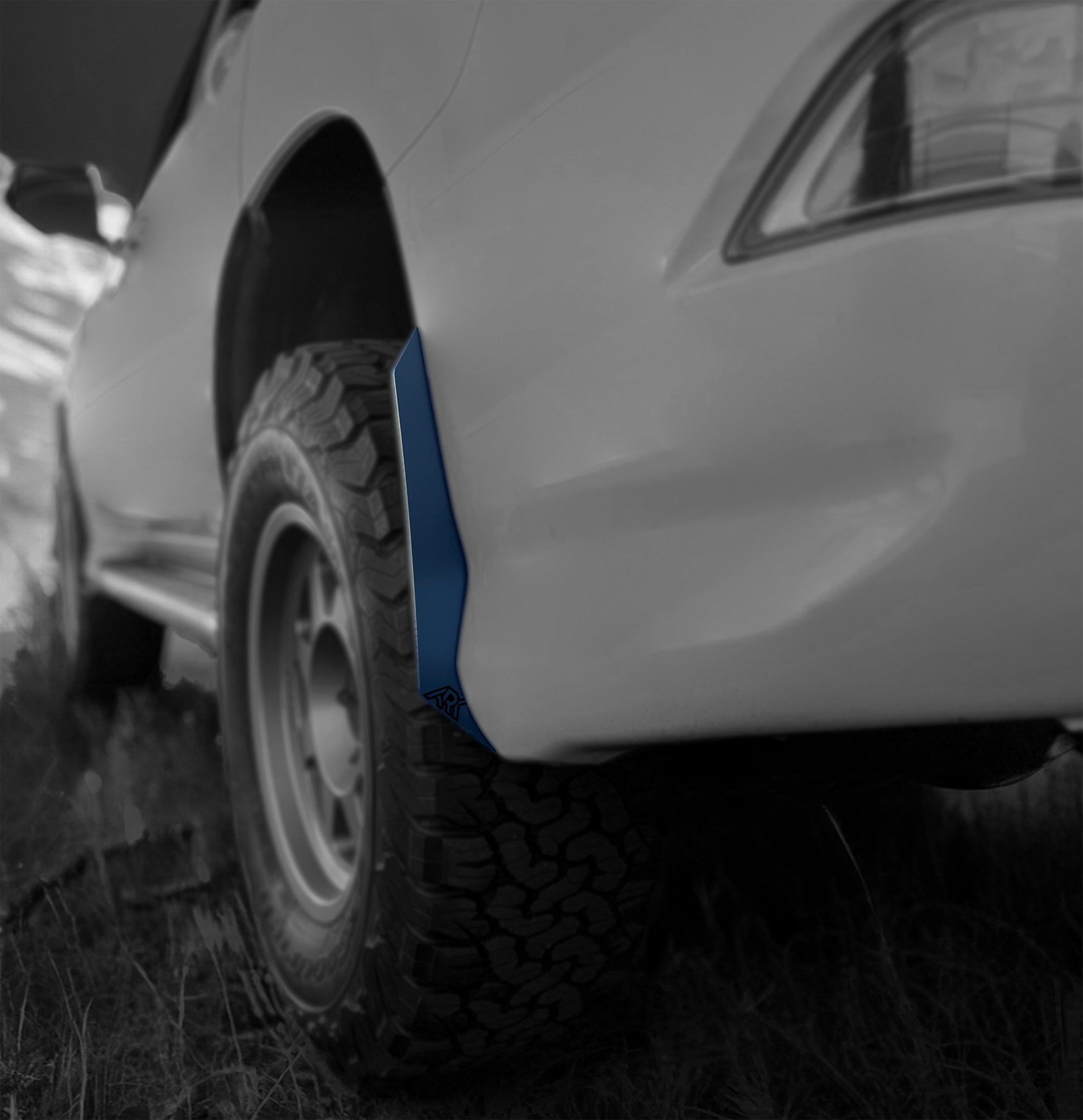 Lexus GX 460 with TriXpoly Micro Flare MudFlap Deletes showcasing a sleek design and rugged tire in an outdoor setting.