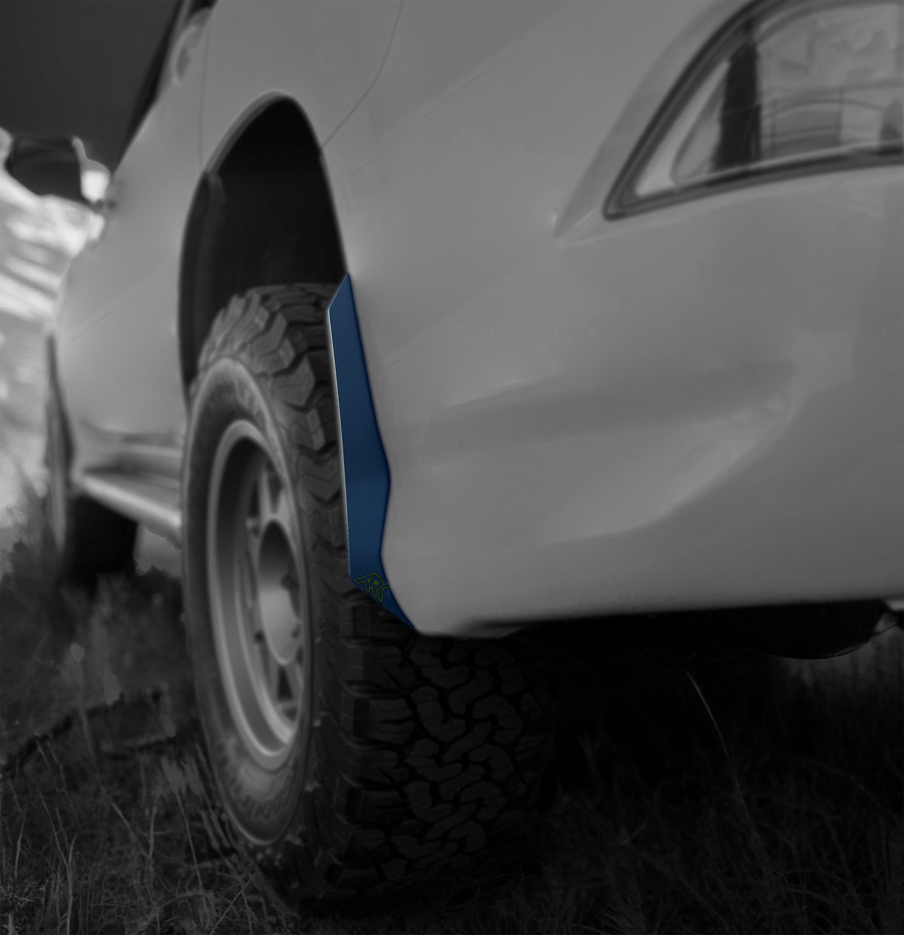 Lexus GX 460 with TriXpoly Micro Flare MudFlap Deletes showcasing a sleek design and rugged tire in an outdoor setting.